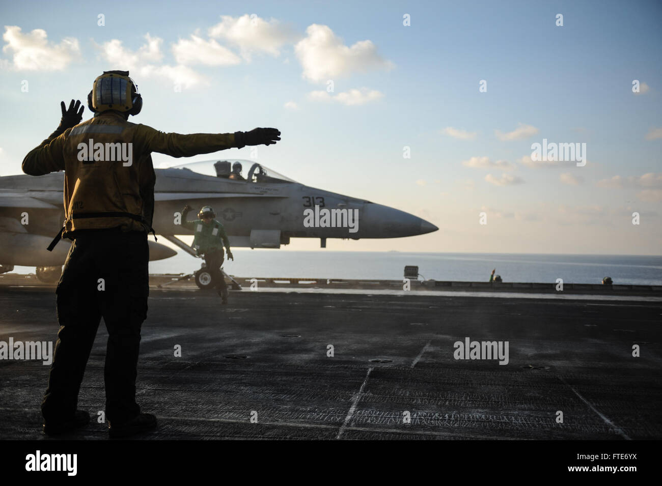 Sailors prepare an F/A-18F Super Hornet, assigned to the “Black Knights” of Strike Fighter Squadron (VFA) 154, for launch from the flight deck of the aircraft carrier USS Nimitz (CVN 68). Nimitz is deployed supporting maritime security operations and theater security cooperation efforts in the U.S. 6th Fleet area of responsibility. (U.S. Navy photo by Mass Communication Specialist Seaman Siobhana R. McEwen/ Released) Stock Photo