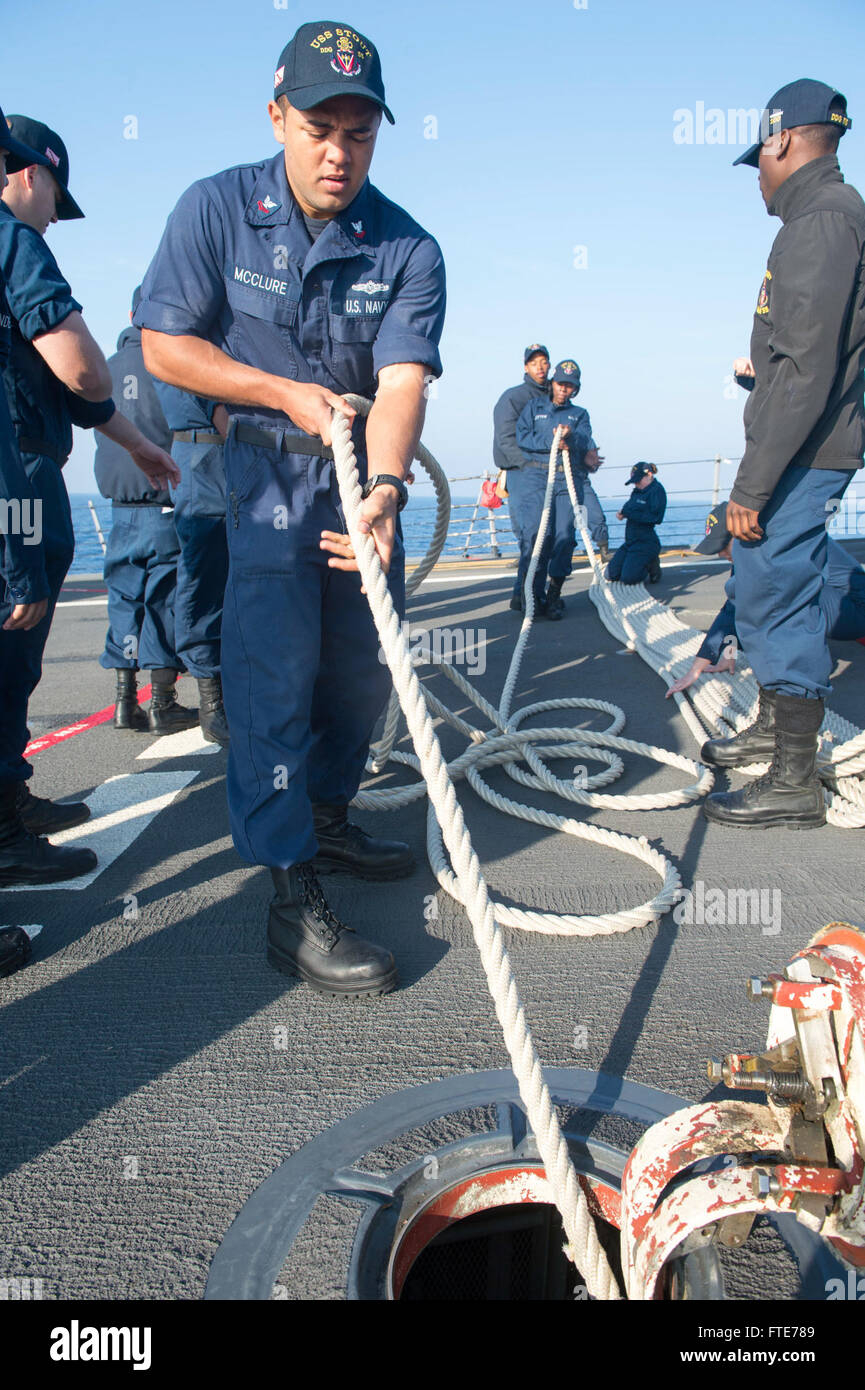 MEDITERRANEAN SEA (Nov. 03, 2013) - Cryptology Technician (Maintenance) 2nd Class Marcus Mcclure pulls mooring lines onto the forecastle of the Arleigh Burke-class guided-missile destroyer USS Stout (DDG 55) before pulling into Aksaz Naval Base, Turkey, for a scheduled port visit. Stout, homeported in Norfolk, Va., is on a scheduled deployment supporting maritime security operations and theater security cooperation efforts in the U.S. 6th Fleet area of operation. (U.S. Navy photo by Mass Communication Specialist 2nd Class Amanda R. Gray/Released) Stock Photo