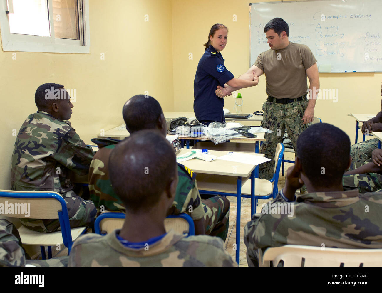 DJIBOUTI, Djibouti (Nov. 13, 2013) - Dutch Royal Navy Cpl. Kim Schild demonstrates methods to control bleeding to Djiboutian, Sudanese and Rwandan military members during Exercise Cutlass Express 2013 at the Port of Djibouti. Exercise Cutlass Express 2013 is a U.S.-facilitated, European-supported multinational maritime exercise in the waters off East Africa designed to improve cooperation, tactical expertise and information sharing practices among East Africa maritime forces to increase maritime safety and security in the region. (U.S. Air Force photo by Staff Sgt. Chad Warren) Stock Photo