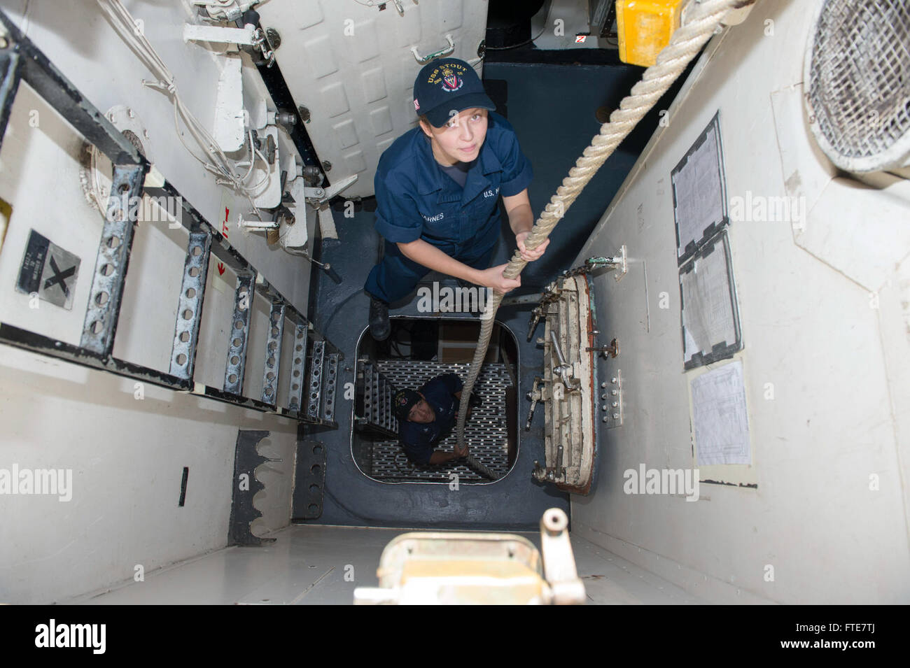 131116-N-UD469-316: AKSAZ, Turkey (Nov. 16, 2013) - Gunner's Mate Seaman Amber Barnes, top, and Fire Controlman 3rd Class Lance Simon send mooring lines below deck aboard the Arleigh Burke-class guided-missile destroyer USS Stout (DDG 55) as the ship departs Aksaz Naval Base. Stout, homeported in Norfolk, Va., is on a scheduled deployment supporting maritime security operations and theater security cooperation efforts in the U.S. 6th Fleet area of operation. (U.S. Navy photo by Mass Communication Specialist 2nd Class Amanda R. Gray/Released) Stock Photo