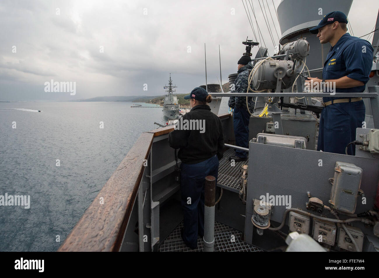 131116-N-VC236-026: SOUDA BAY, Greece (Nov. 16, 2013) - Lt.j.g. Shane Macedo, right, stands by as Ensign Brittney White relays orders to the aft, top-side roving watch stander during an Anti-Terrorism Tactical Watch Officer (ATTWO) training scenario aboard the Arleigh Burke-class guided-missile destroyer USS Ramage (DDG 61). Ramage is on a scheduled deployment supporting maritime security operations and theater security cooperation efforts in the U.S. 6th Fleet area of operations. (U.S. Navy Photo by Mass Communication Specialist 3rd Class Jackie Hart/Released) Stock Photo