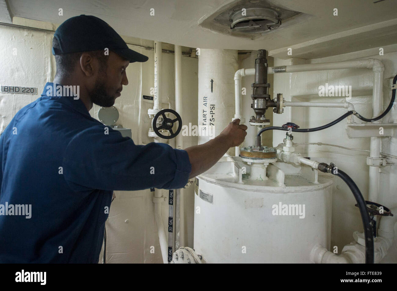 131126-N-VC236-005: SOUDA BAY, Greece (Nov. 26, 2013) - Gas Turbine System Technician (Mechanical) Fireman Gerard Plowden checks a valve while preparing to fill a gas turbine water wash tank aboard the Arleigh Burke-class guided-missile destroyer USS Ramage (DDG 61). Ramage is on a scheduled deployment supporting maritime security operations and theater security cooperation efforts in the U.S. 6th Fleet area of operations. (U.S. Navy Photo by Mass Communication Specialist 3rd Class Jackie Hart/Released) Stock Photo