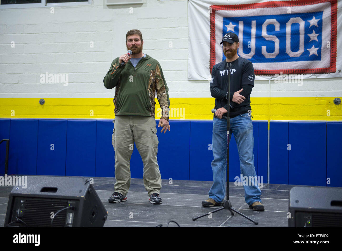 SOUDA BAY, Greece  (Dec. 08, 2013) -   Former offensive tackle for the New England Patriots, Matt Light, and Washington Nationals baseball player Adam LaRoche entertains the crowd of Sailors, Marines, and Airman at the annual USO holiday tour at Naval Support Activity (NSA) Souda Bay.  The tour features a variety of other celebrities and the Chairman of the Joint Chiefs of Staff visiting four countries and five bases to interact with the troops for the holidays.  Stout, homeported in Norfolk, Va., is on a scheduled deployment supporting maritime security operations and theater security coopera Stock Photo