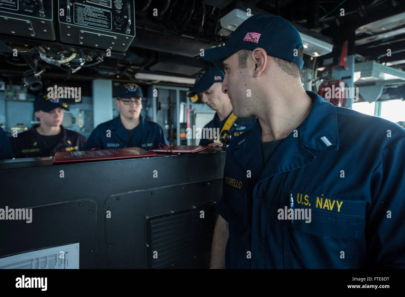 131209-N-VC236-008: MEDITERRANEAN SEA (Dec. 9, 2013) - Lt.j.g. Andy Muscarello, right, gives directions to the helm during a simulated loss of steering drill aboard the Arleigh Burke-class guided-missile destroyer USS Ramage (DDG 61). Ramage, homeported in Norfolk, Va., is on a scheduled deployment supporting maritime security operations and theater security cooperation efforts in the U.S. 6th Fleet area of operations. (U.S. Navy Photo by Mass Communication Specialist 3rd Class Jackie Hart/Released) Stock Photo