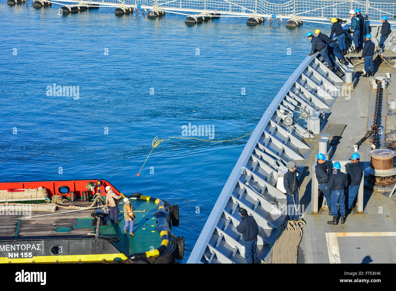 On December 14, 2013, the USS Monterey (CG 61) tossed a heaving line to a tug boat as it departed Souda Bay, Greece, after a port visit. The USS Monterey was engaged in maritime security operations and theater security cooperation efforts in the U.S. 6th Fleet area of operations. Stock Photo