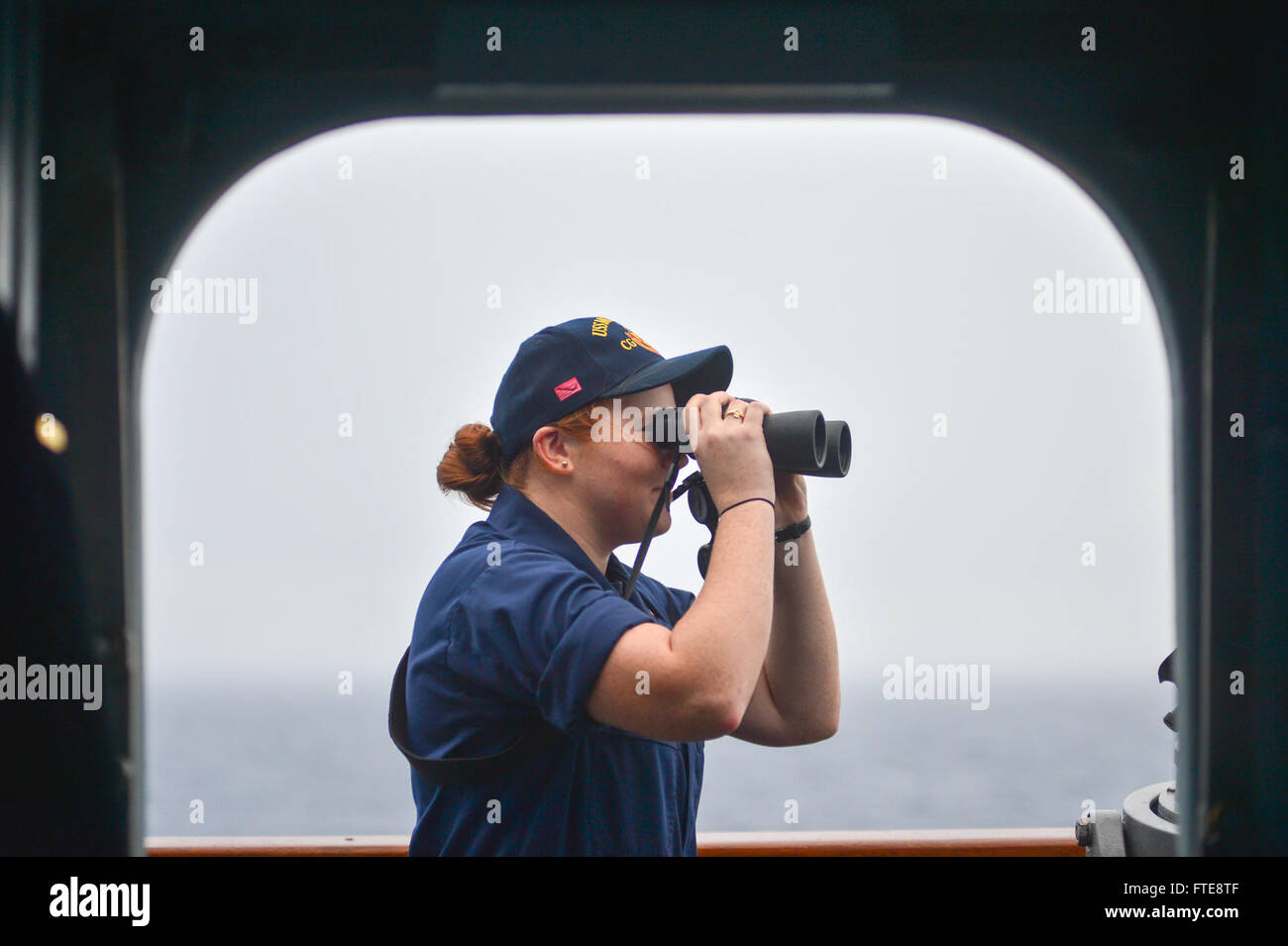 131227-N-QL471-286: ATLANTIC OCEAN (Dec. 27, 2013) - Ensign Stephanie Gies looks for contacts as the guided-missile cruiser USS Monterey (CG 61) transits the Atlantic Ocean. Monterey is scheduled to return to homeport in Norfolk after a nine-month deployment to the U.S. 5th and 6th Fleet areas of operations. (U.S. Navy photo by Mass Communication Specialist 2nd Class Billy Ho/Released) Stock Photo