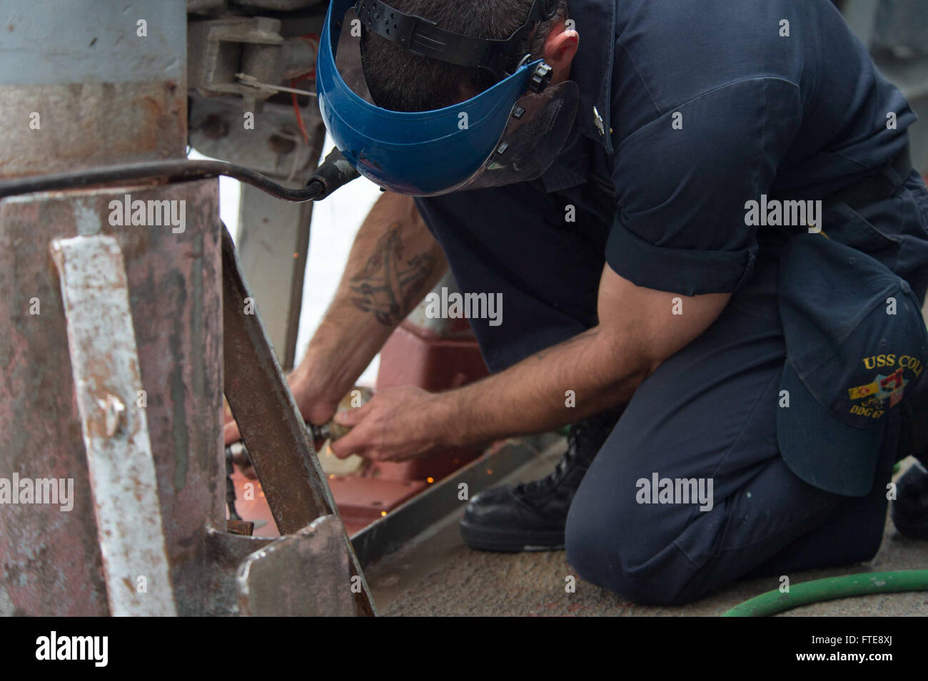 150127-N-TC720-044 MEDITERRANEAN SEA (Jan. 27, 2015) Boatswain’s Mate 1st Class Alan Farthing, from Grove City, Ohio, conducts preventative maintenance aboard USS Cole (DDG 67) Jan. 27, 2015. Cole, an Arleigh Burke-class guided-missile destroyer, homeported in Norfolk, is conducting naval operations in the U.S. 6th Fleet area of operations in support of U.S. national security interests in Europe. (U.S. Navy photo by Mass Communication Specialist 3rd Class Mat Murch/Released) Stock Photo