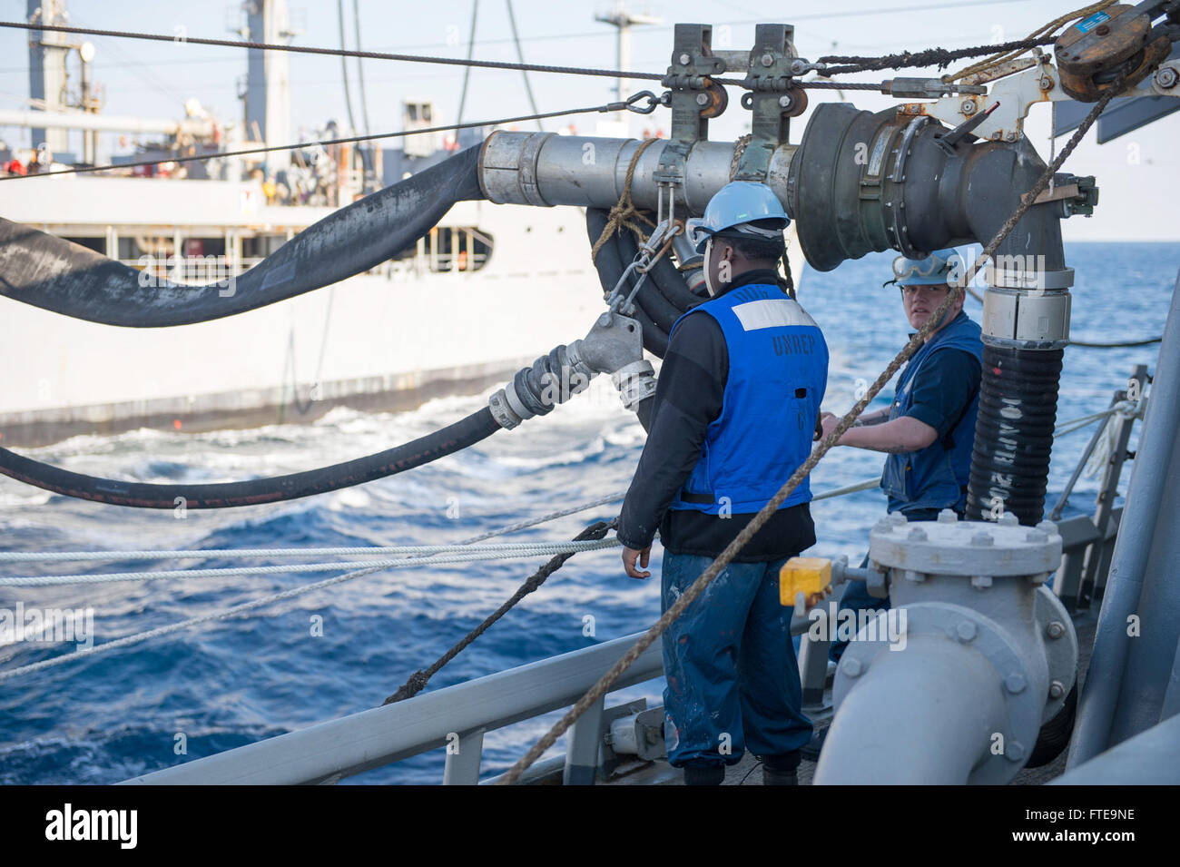 140208-N-UD469-139: MEDITERRANEAN SEA (Feb. 8, 2014) - Seaman Apprentice Aaron Laster, right, and Seaman Apprentice William Cruz monitor a fuel probe aboard the Arleigh Burke-class guided-missile destroyer USS Stout (DDG 55) during a replenishment-at-sea with the Military Sealift Command fleet replenishment oiler, USNS John Lenthall (T-AO 189). Stout, homeported in Norfolk, Va., is on a scheduled deployment supporting maritime security operations and theater security cooperation efforts in the U.S. 6th Fleet area of operations. (U.S. Navy photo by Mass Communication Specialist 2nd Class Amanda Stock Photo
