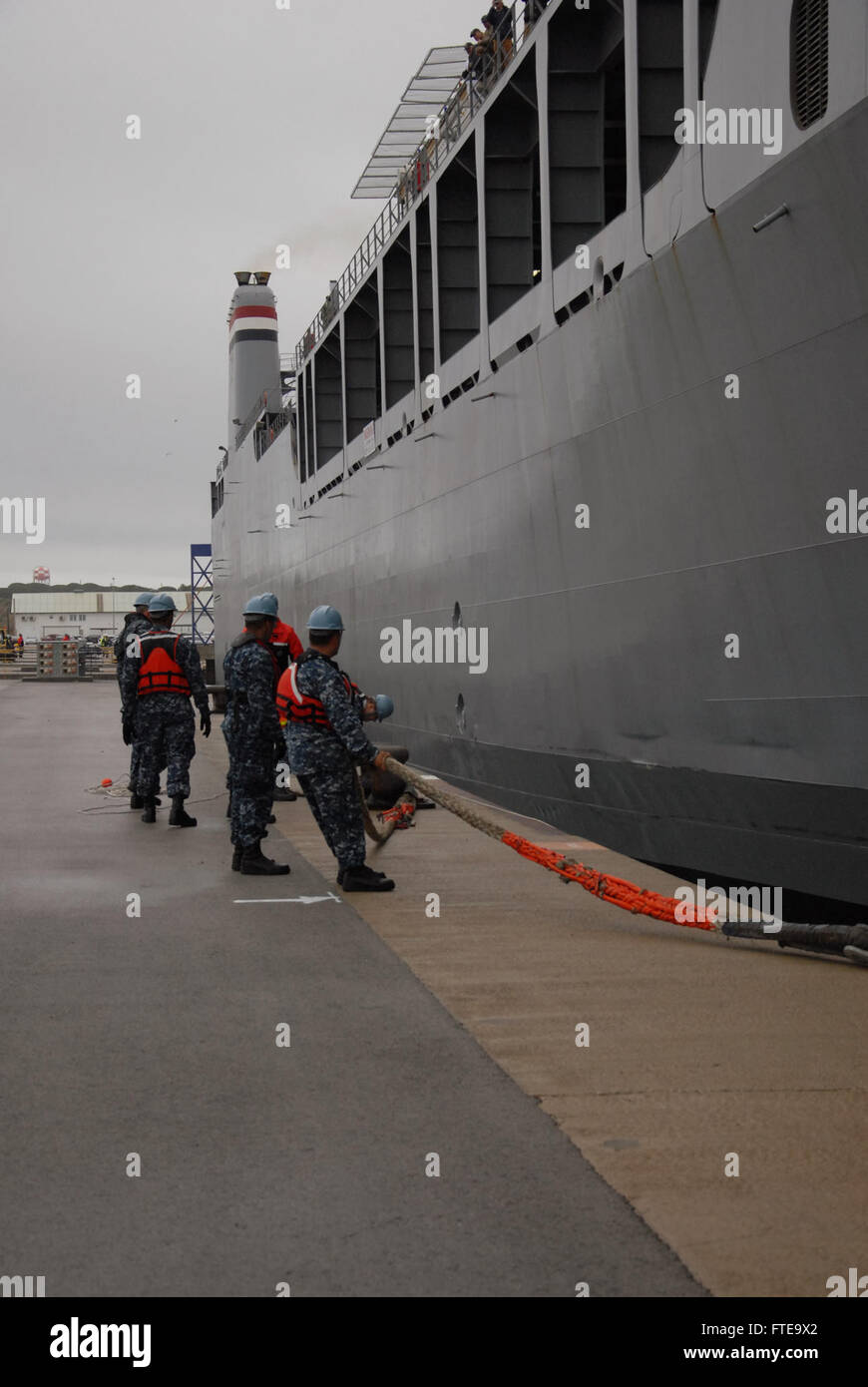 140213-N-UI568-425: ROTA, Spain (Feb. 13, 2014) – Sailors assigned to Naval Station Rota handle lines for the arrival of the container ship MV Cape Ray (T-AKR 9679) for a scheduled port visit. The vessel was modified to contribute to the United Nations and the Organization for the Prohibition of Chemical Weapons joint mission to eliminate Syria's chemical weapons materials. (U.S. Navy photo by Morgan Over/Released) Join the conversation on Twitter ( https://twitter.com/naveur navaf )  follow us on Facebook ( https://www.facebook.com/USNavalForcesEuropeAfrica )  and while you're at it check us  Stock Photo