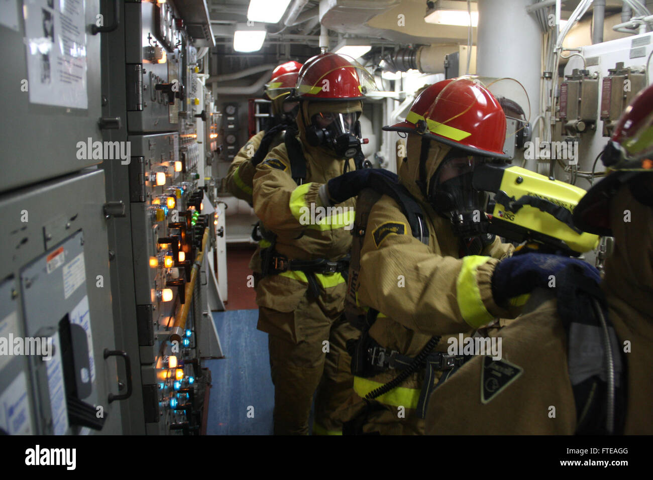 140301-N-ZZ999-001: INDIAN OCEAN (March 1, 2014) - An inspection team explores the safety of Main Engine Room 2 during a simulated major fuel oil leak as part of a damage control training drill aboard the guided-missile destroyer USS Nitze (DDG 94). Nitze, homeported in Norfolk, Va.,  is on a scheduled deployment supporting maritime security operations and theater security cooperation efforts in the U.S. 6th Fleet area of operation. (U.S. Navy photo by Lt.j.g. Tyler Hammett) Stock Photo