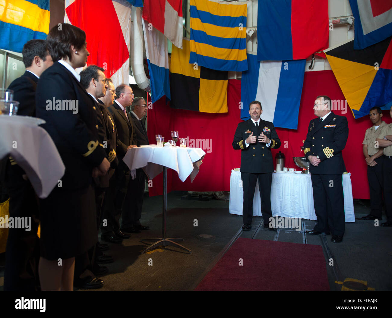 140228-N-SK590-116: CARTAGENA, Spain (Feb. 28, 2014) - Cmdr. Kenneth Anderson, executive officer of the guided-missile frigate USS Simpson (FFG 56), addresses guests during a reception aboard Simpson. Simpson is on a scheduled deployment conducting maritime security operations and theater security cooperation efforts in the 6th fleet area of operations. (U.S. Navy photo by Mass Communication Specialist 2nd Class Tim D. Godbee/Released) Stock Photo