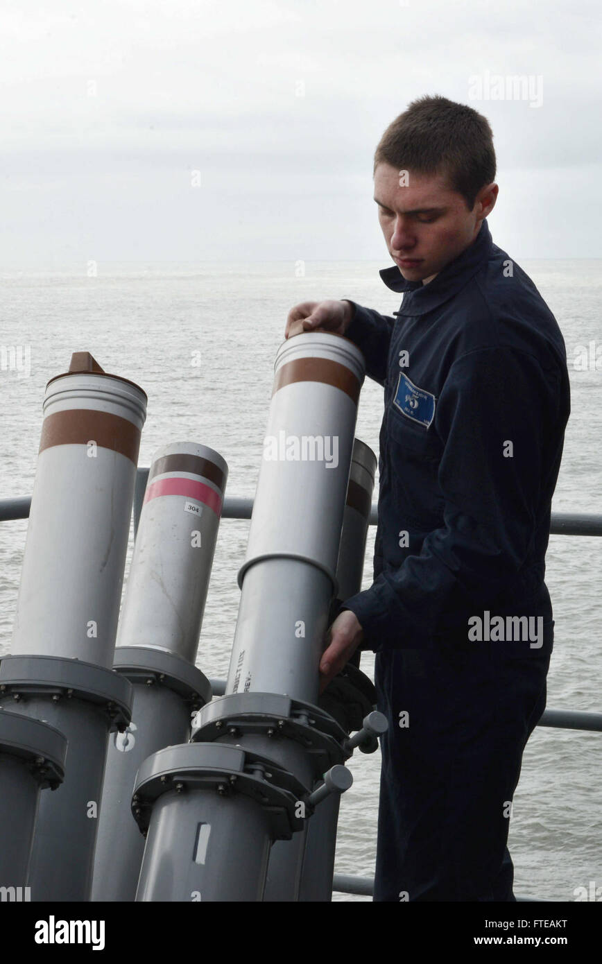 140303-N-HO612-056: ATLANTIC OCEAN (March 2, 2014) - Cryptologic Technician (Technical) Seaman Bruin Hill loads anti-ship missile defense chaff  rounds in the Decoy Launcher System aboard the multipurpose amphibious assault ship USS Bataan (LHD 5). The Bataan Amphibious Readiness Group is on a scheduled deployment supporting maritime security operations, providing crisis response capability and conducting theater security cooperation efforts in the U.S. 6th Fleet area of operations. (U.S. Navy Photo by Mass Communication Specialist 3rd Class Erik Foster/ Released) Stock Photo