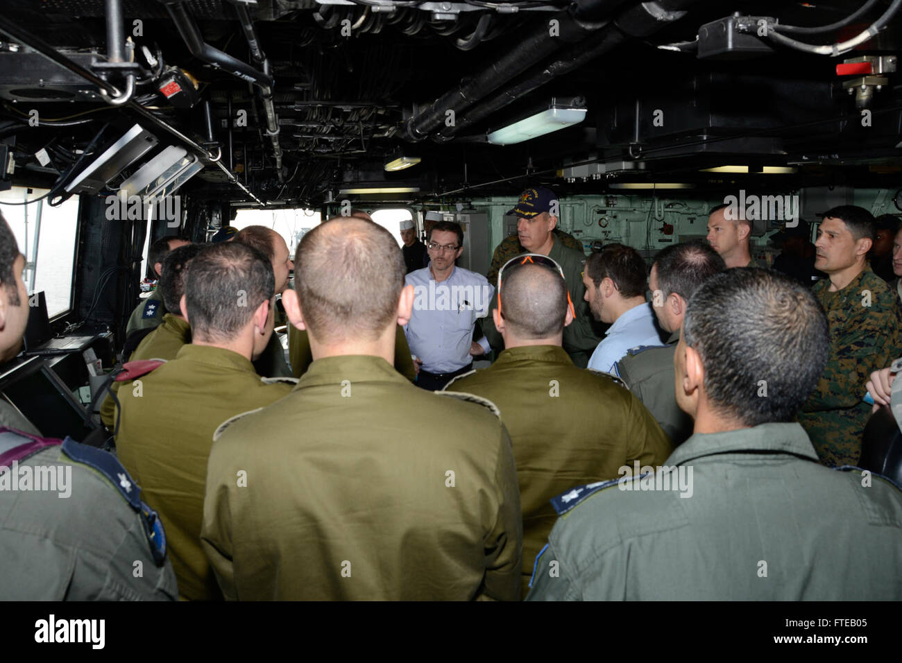 140306-N-HB951-046 MEDITERRANEAN SEA (Mar. 6, 2014) – Capt. Kenneth J. Reynard, commanding officer of amphibious transport dock ship USS Mesa Verde (LPD 19), gives a tour of the bridge to distinguished visitors, including Israeli Air Force Chief of Staff Brig. Gen. Hagi Topolansky and William Grant, deputy chief of mission in Tel Aviv, Israel. Mesa Verde Sailors and Marines assigned to 22nd Marine Expeditionary Unit (MEU) are deployed supporting maritime security operations, providing crisis response capability, increasing theater security cooperation and a forward naval presence in the U.S. 5 Stock Photo