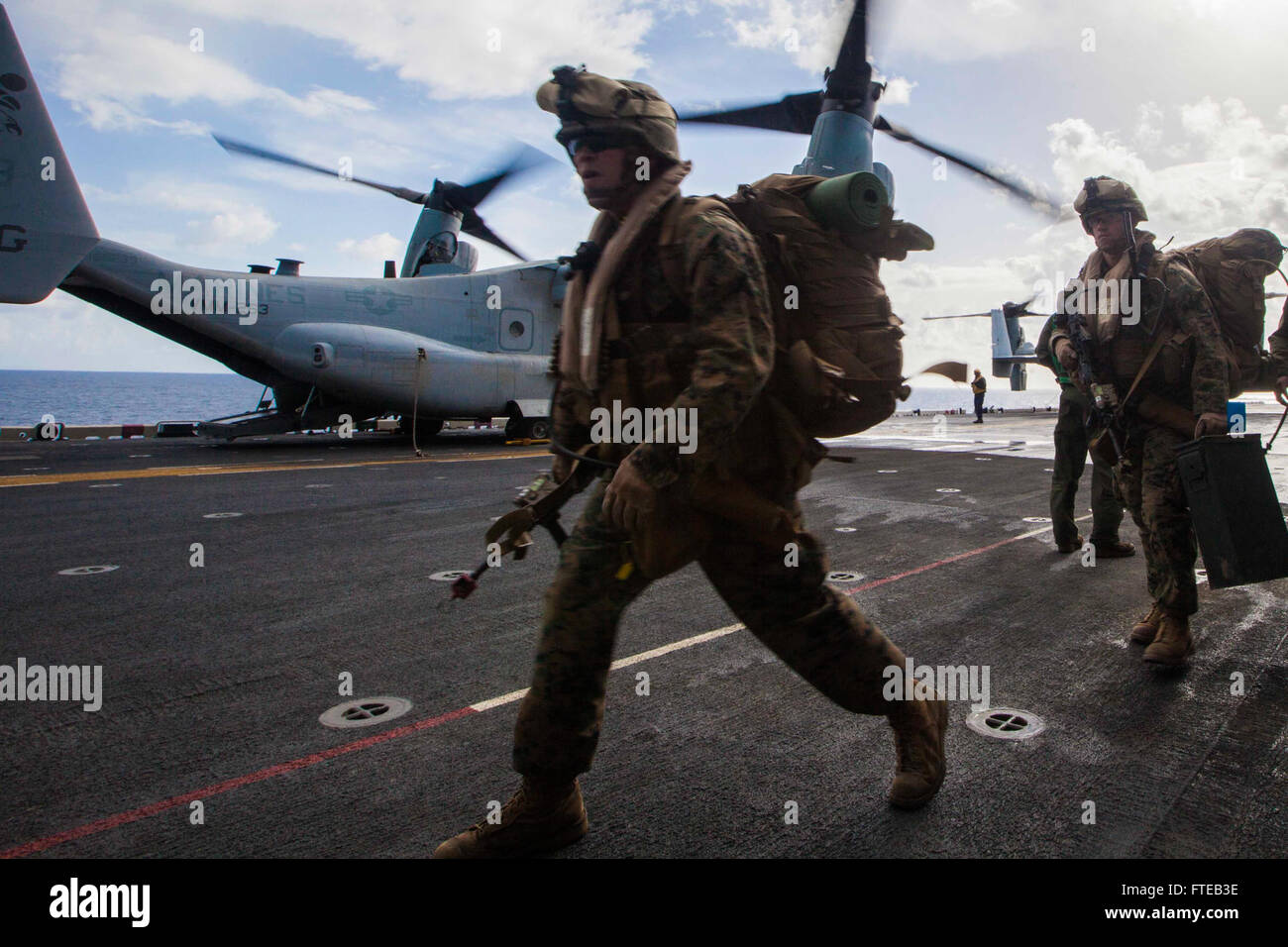 140307-M-HZ646-126: USS BATAAN, at sea (March 7, 2014) - U.S. Marines and Sailors with Battalion Landing Team 1st Battalion, 6th Marine Regiment, 22nd Marine Expeditionary Unit (MEU), load onto an MV-22 Osprey aircraft aboard the USS Bataan (LHD 5) for a bilateral exercise with the Hellenic Army in Greece, March 7. As NATO allies, the U.S. and Greece regularly conduct scheduled military exercises to strengthen professional and personal relationships. The MEU is deployed to the U.S. 6th Fleet area of operations with the Bataan Amphibious Ready Group as a sea-based, expeditionary crisis response Stock Photo