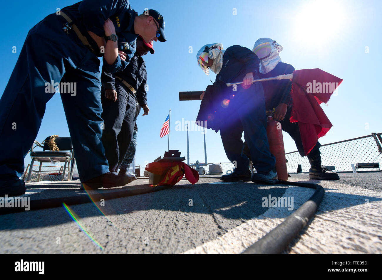 U.S. Navy sailors perform a crash and salvage drill on the USS Arleigh ...