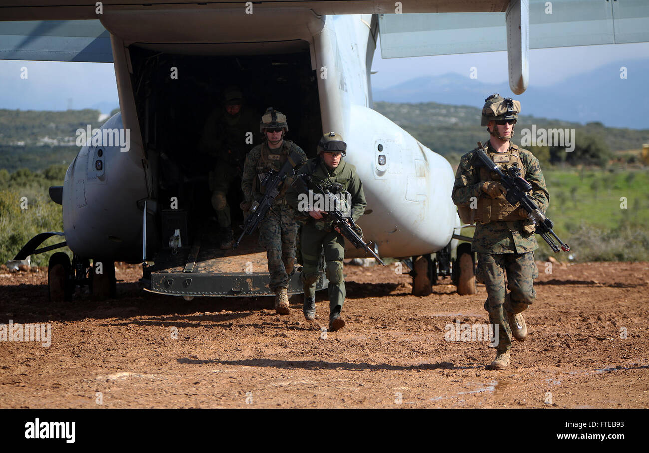 140308-M-WB921-085 GREECE (March 8, 2014) - U.S. Marines with Battalion Landing Team 1st Battalion, 6th Marine Regiment, 22nd Marine Expeditionary Unit (MEU), and members of the Hellenic Army exit an MV-22 Osprey aircraft during a bilateral training exercise. The U.S. and Greece regularly conduct scheduled military exercises to strengthen professional and personal relationships. The MEU is deployed to the U.S. 6th Fleet area of operations with the Bataan Amphibious Ready Group as a sea-based, expeditionary crisis response force capable of conducting amphibious missions across the full range of Stock Photo