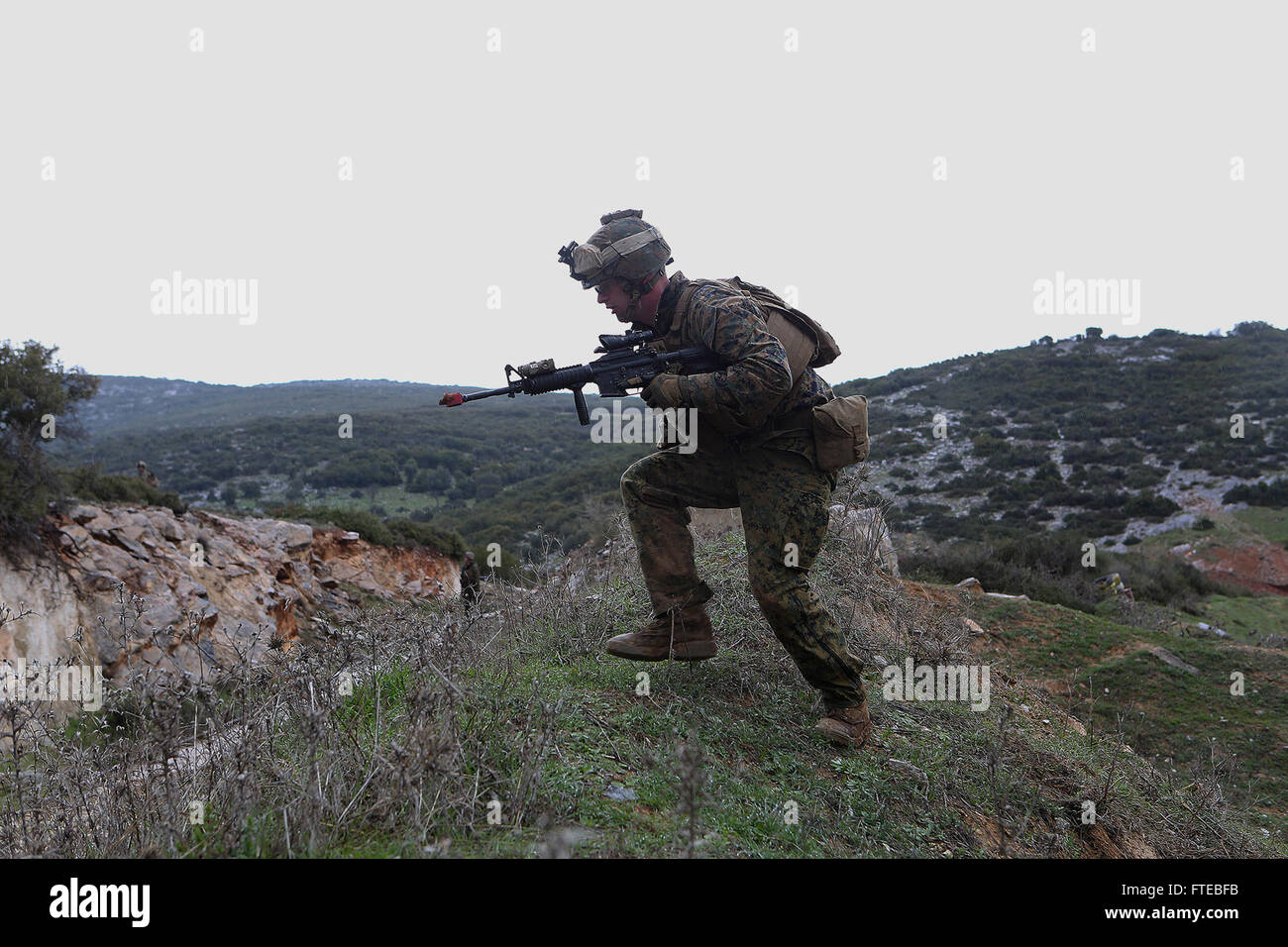 140309-M-WB921-492 GREECE (March 9, 2014) - A U.S. Marine with Battalion Landing Team 1st Battalion, 6th Marine Regiment, 22nd Marine Expeditionary Unit (MEU), assaults a hill during a bilateral training exercise with the Hellenic Army. The U.S. and Greece regularly conduct scheduled military exercises to strengthen professional and personal relationships. The MEU is deployed to the U.S. 6th Fleet area of operations with the Bataan Amphibious Ready Group as a sea-based, expeditionary crisis response force capable of conducting amphibious missions across the full range of military operations. ( Stock Photo