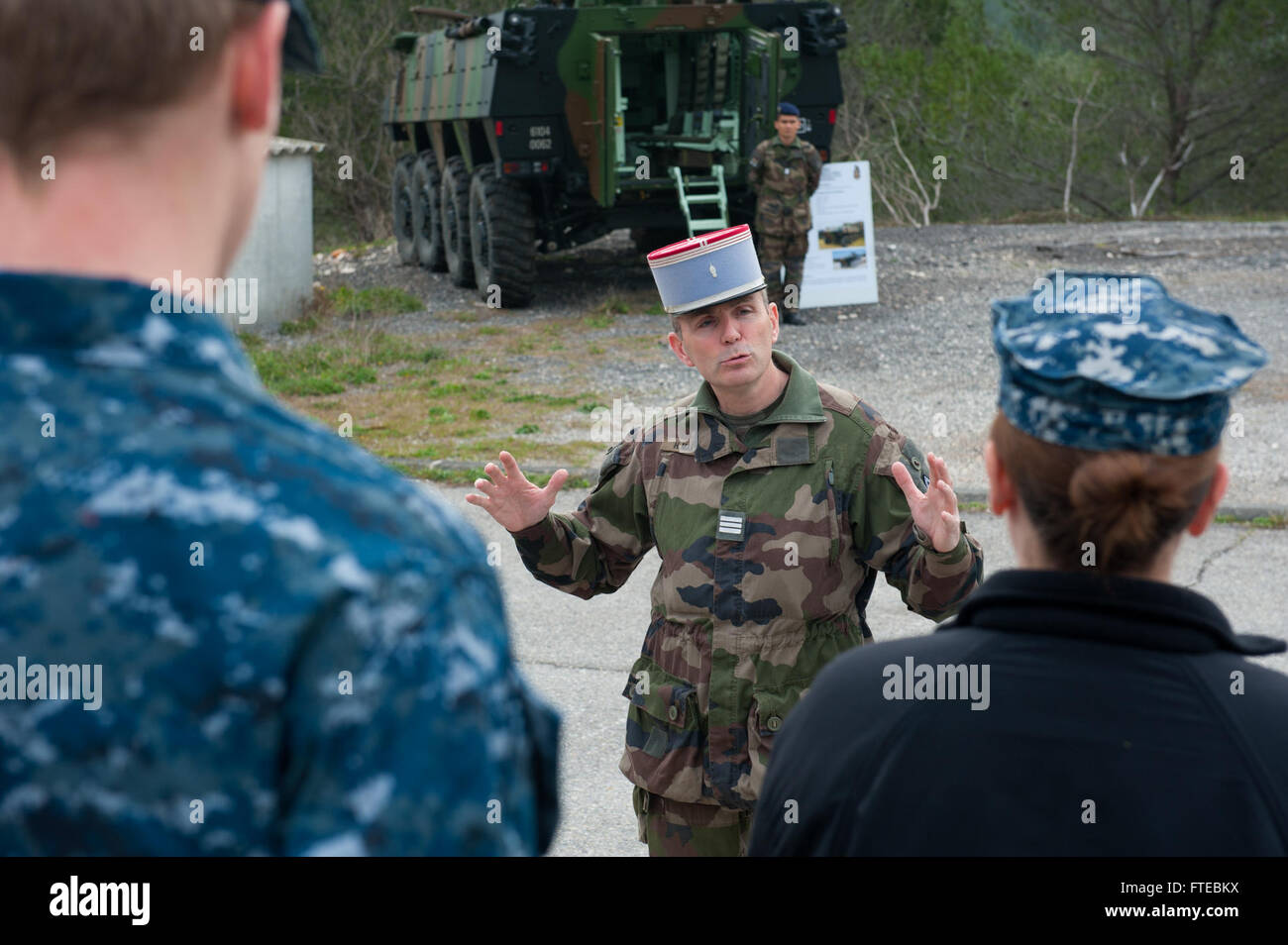 140311-N-WD757-073 MARSEILLE, France (March 11, 2014) – French Army Capt. Herve Martin, assigned to the Armée De Terre 4e Regiment De Dragons tank regiment, explains the unit’s military vehicles to Sailors assigned to the guided-missile destroyer USS Arleigh Burke (DDG 51) while the ship is on a scheduled port visit to Marseille, France. Arleigh Burke is on a scheduled deployment in support of maritime security operations and theater security cooperation efforts in the U.S. 6th Fleet area of operations. (U.S. Navy photo by Mass Communication Specialist 2nd Class Carlos M. Vazquez II/Released)  Stock Photo