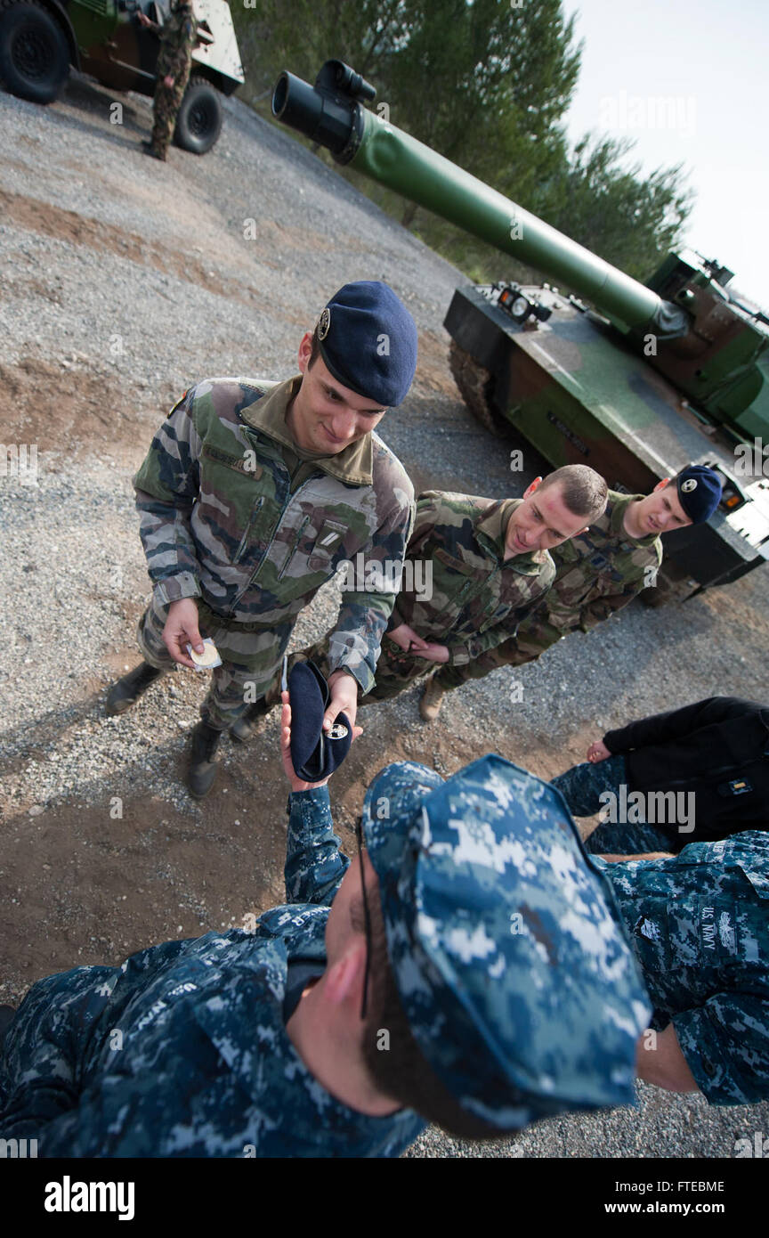 140311-N-WD757-270 MARSEILLE, France (March 11, 2014) – Machinist’s Mate Fireman Kyler Staiger, assigned to the guided-missile destroyer USS Arleigh Burke (DDG 51), exchanges gifts with a French soldier, assigned to the Armée De Terre 4e Regiment De Dragons tank regiment while the ship is on a scheduled port visit to Marseille, France. Arleigh Burke is on a scheduled deployment in support of maritime security operations and theater security cooperation efforts in the U.S. 6th Fleet area of operations. (U.S. Navy photo by Mass Communication Specialist 2nd Class Carlos M. Vazquez II/Released)  J Stock Photo