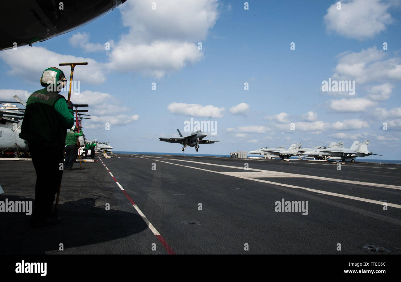 140315-N-SI489-197  MEDITERRANEAN SEA (March 15, 2014) Aviation Boatswain’s Mate (Equipment) Airman Justin Fortin, from Titusville, Fla., waits to recover the arresting cable while an F/A-18F Super Hornet, attached to the “Fighting Black Lions” of Strike Fighter Squadron (VFA) 213, prepares to land on the flight deck aboard the aircraft carrier USS George H.W. Bush (CVN 77). George H. W. Bush is on a scheduled deployment supporting maritime security operations and theater security cooperation efforts in the U.S. 6th Fleet area of operations. (U.S. Navy photo by Mass Communication Specialist Se Stock Photo