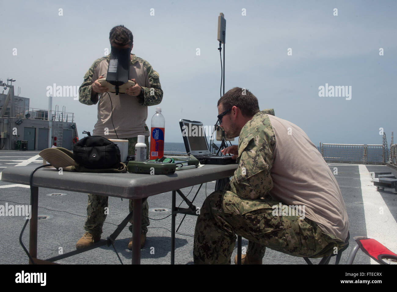 140327-N-ZY039-014  GULF OF GUINEA (March 27, 2014) - Fire Controlman 2nd Class Dustin Gower, and Hull Technician 2nd Class Paul Hobson, both assigned to the PUMA unmanned aerial vehicle (UAV) detachment aboard joint, high-speed vessel USNS Spearhead (JHSV 1) operate a UAV during flight operations as part of a U.S.-Ghana combined maritime law enforcement operation under the African Maritime Law Enforcement Partnership (AMLEP) program. AMLEP, the operational phase of Africa Partnership Station (APS), brings together U.S. Navy, U.S. Coastguard, and respective Africa partner maritime forces to ac Stock Photo