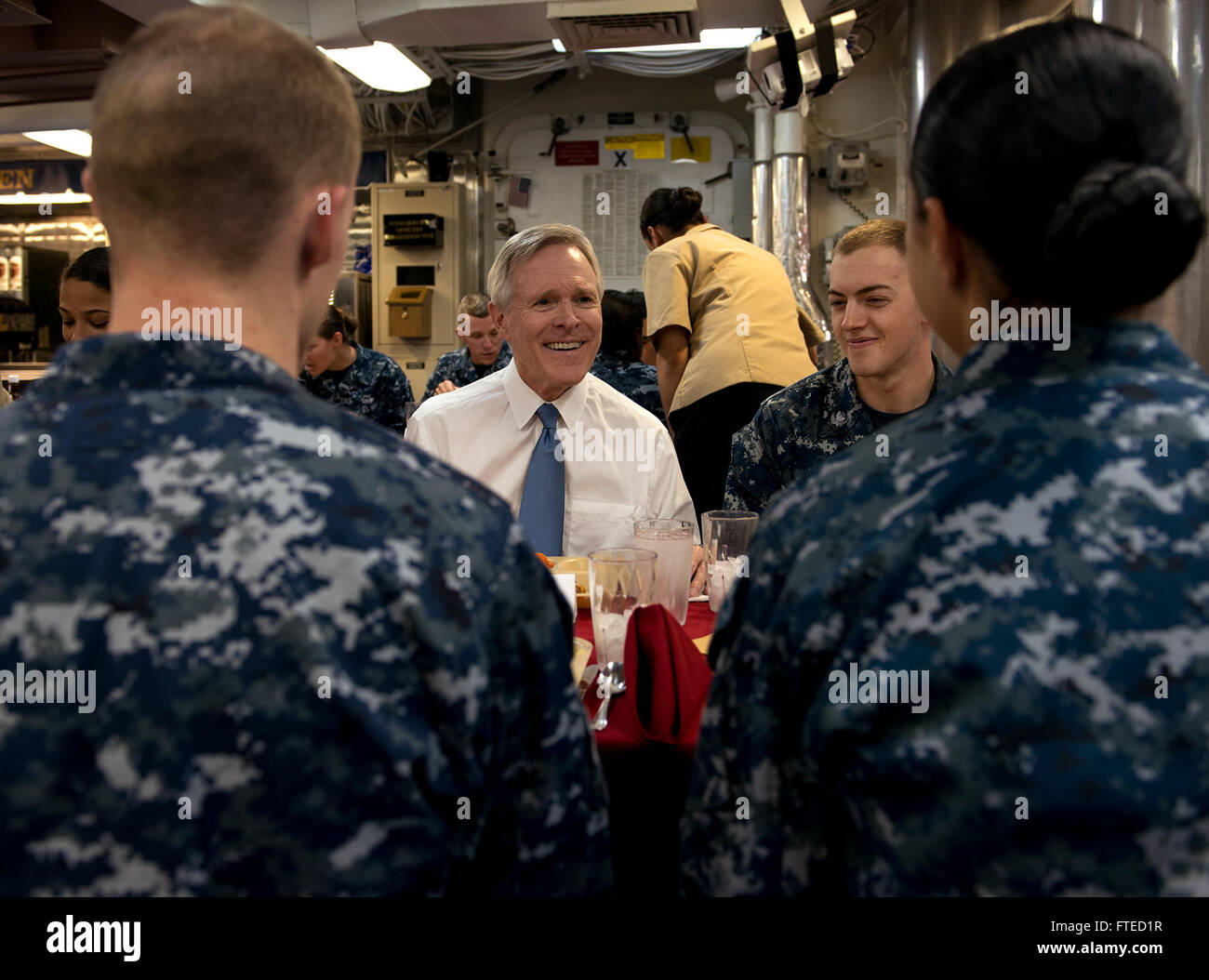 MEDITERRANEAN SEA (April 1, 2014) - Secretary of the Navy Ray Mabus converses with Sailors during his lunch with members of the crew on board the guided-missile destroyer USS Bulkeley (DDG 84). Bulkeley, deployed as part of Harry S. Truman Carrier Strike Group, is operating in the U.S. 6th Fleet area of operations in support of maritime security operations and theater security cooperation efforts as it completes a 9-month deployment to the U.S. 5th and 6th Fleet areas of operations. Stock Photo