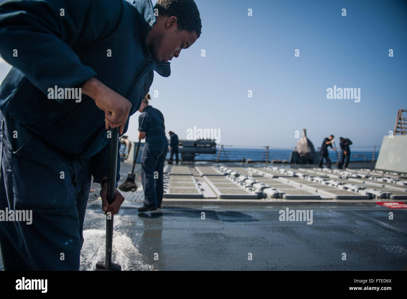 140408-N-EI510-004 MEDITERRANEAN SEA (April 08, 2014) - Sonar Technician (Surface) Seaman Apprentice Gregory Harris, from Lancaster, Texas, participates in a fresh water wash down aboard the Arleigh Burke-class guided-missile destroyer USS Truxtun (DDG 103). Truxtun is deployed as part of the George H.W. Bush Carrier Strike Group on a scheduled deployment supporting maritime security operations and theater security cooperation efforts in the U.S. 5th Fleet area of responsibility. (U.S. Navy photo by Mass Communication Specialist 3rd Class Scott Barnes/Released) Stock Photo