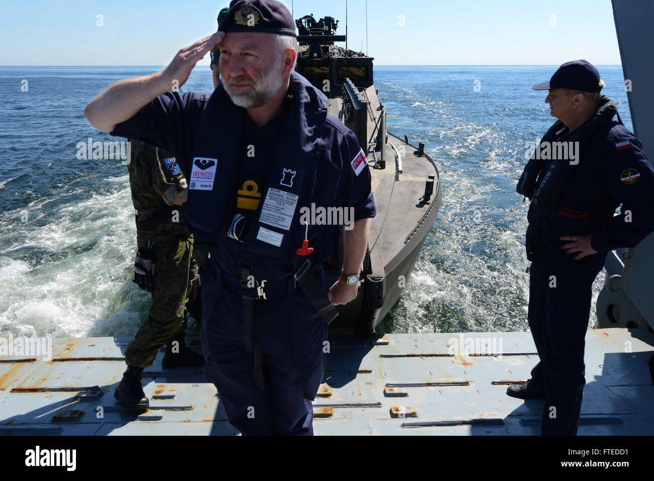 150610-N-SL539-094 BALTIC SEA - (June 10, 2015) â Royal Navy Rear Admiral Tim Lowe Salutes as he boards the Polish navy ship, ORP Gniezno, during BALTOPS 2015. BALTOPS is an annual multinational exercise designed to enhance flexibility and interoperability, as well as demonstrate resolve among allied and partner forces to defend the Baltic region. (U.S. Navy photo by Mass Communication Specialist Seaman Lucas Askew/Released) Stock Photo