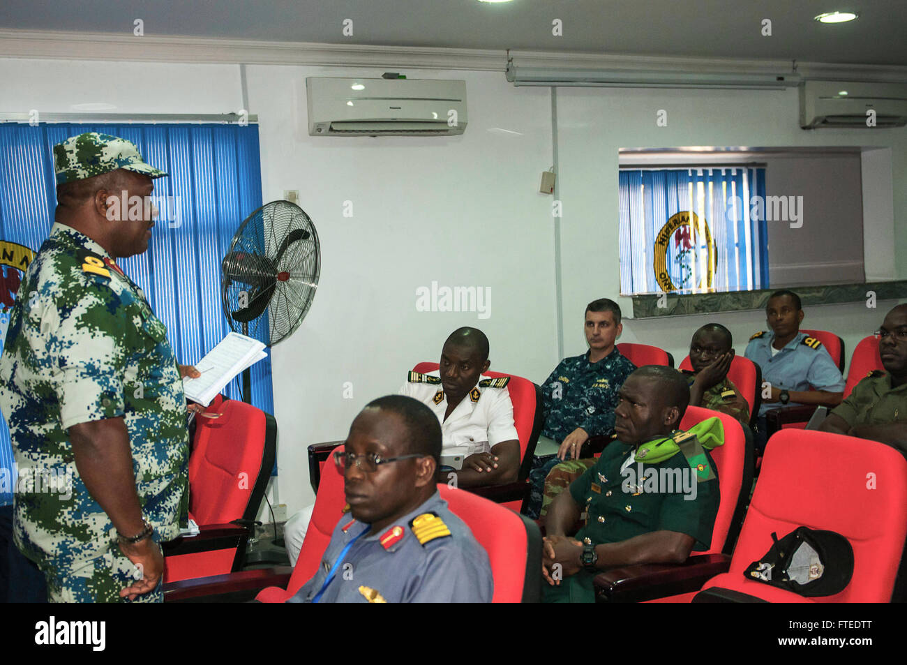 140420-N-ZE250-021 LAGOS, Nigeria (April 20, 2014) - Nigerian navy Commodore AK Owhor-chuku, national multi-force commander of Obangame Express 2014, briefs African military personnel about upcoming events at the exercise headquarters, Nigerian Western Naval Command. Obangame Express is a U.S. Africa Command-sponsored multinational maritime exercise designed to increase maritime safety and security in the Gulf of Guinea.   (U.S. Navy Photo by Mass Communication Specialist Weston Jones/Released)  Join the conversation on <a href='https://twitter.com/naveur navaf' rel='nofollow'>Twitter</a> foll Stock Photo