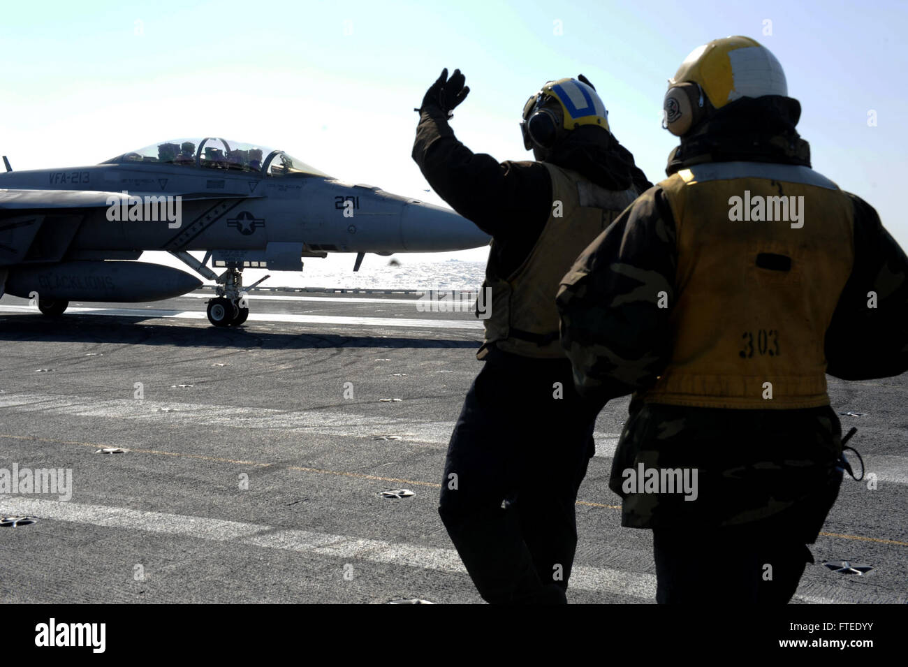 140313-N-EY632-322  MEDITERRENEAN SEA (March 13, 2014) - Sailors on board the aircraft carrier USS George H.W. Bush (CVN 77) direct an F/A-18F Super Hornet, attached to the &quot;Valions,&quot; of Strike Fighter Squadron (VFA) 213, on the flight deck. George H. W. Bush is on a scheduled deployment supporting maritime security operations and theater security cooperation efforts in the U.S. 6th Fleet area of operations. (U.S. Navy photo by Mass Communication Specialist 2nd Class Joshua K. Horton/Released)  Join the conversation on Twitter ( https://twitter.com/naveur navaf )  follow us on Facebo Stock Photo