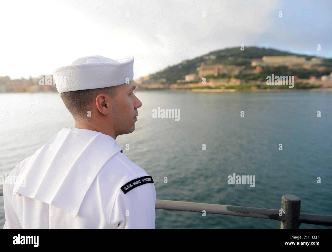 151003-N-VY489-079 GAETA, Italy (Oct. 3, 2015) Electronics Technician 3rd Class Drake Delcambre, from Slidell, Louisiana, mans the rails as the U.S. 6th Fleet command and control ship USS Mount Whitney (LCC 20) pulls into Gaeta, Italy Oct. 3, 2015 after a nine month dry-dock period in Rijeka, Croatia. Mount Whitney, forward deployed to Gaeta, Italy, operates with a combined crew of U.S. Navy Sailors and Military Sealift Command civil service mariners. (U.S. Navy Photo by Mass Communications Specialist 1st Class Mike Wright/Released) Stock Photo