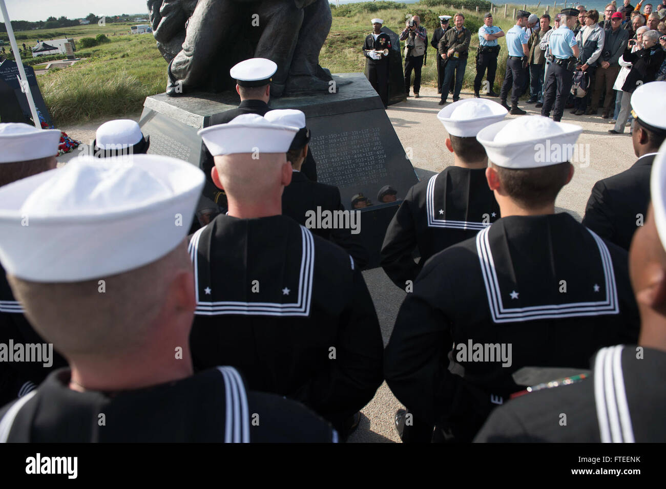 140605-N-YO152-132 UTAH BEACH, France (June 5, 2014) - Sailors assigned to the guided-missile destroyer USS Oscar Austin (DDG 79) stand at parade rest while awaiting commencement of the D-Day ceremony at the Navy Memorial on Utah Beach. The event was one of several commemorations of the 70th Anniversary of D-Day operations conducted by Allied forces World War II June 5-6, 1944. Over 650 U.S. military personnel have joined troops from several NATO nations to participate in ceremonies to honor the events at the invitation of the French government. (U.S. Navy photo by Mass Communication Specialis Stock Photo