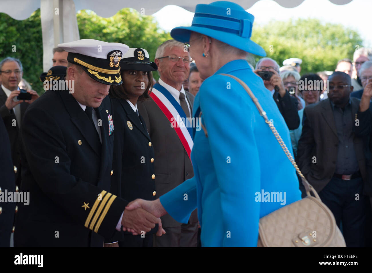 140606-N-YO152-052 UTAH BEACH, France (June 6, 2014) - HM Margrethe II of Denmark greets Cmdr. Brian Diebold, commanding officer of USS Oscar Austin (DDG 79), at a wreath laying ceremony just off the coast of Utah Beach. The event was one of several commemorations of the 70th Anniversary of D-Day operations conducted by Allied forces World War II June 5-6, 1944. Over 650 U.S. military personnel have joined troops from several NATO nations to participate in ceremonies to honor the events at the invitation of the French government. (U.S. Navy photo by Mass Communication Specialist 3rd Class (SW) Stock Photo