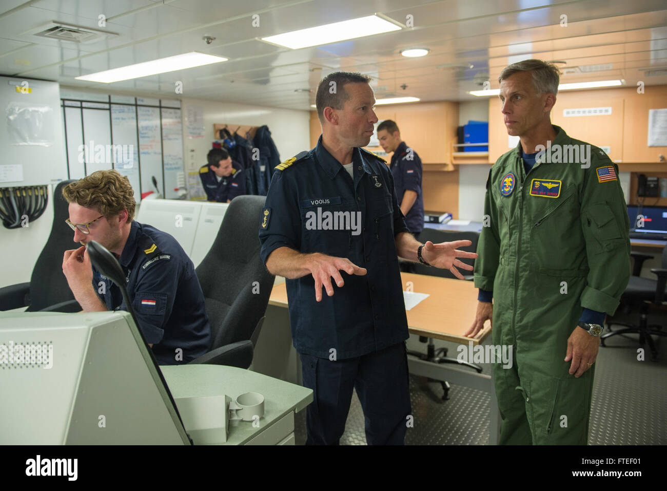 140612-N-EZ054-150 BALTIC SEA (June 12, 2014) -  Royal Netherlands Navy Kapitein-luitenant-ter-Zee Wiggert Vooijs speaks with Rear Adm. Rick Snyder, commander task force 162, about the ongoing operations on the HNLMS Friesland during Baltic Operations (BALTOPS) 2014. Now in its 42nd year, BALTOPS is an annual, multinational exercise to enhance maritime capabilities and interoperability, and to support regional stability. (U.S. Navy photo by Mass Communication Specialist 3rd Class Luis R. Chavez Jr/Released) Stock Photo