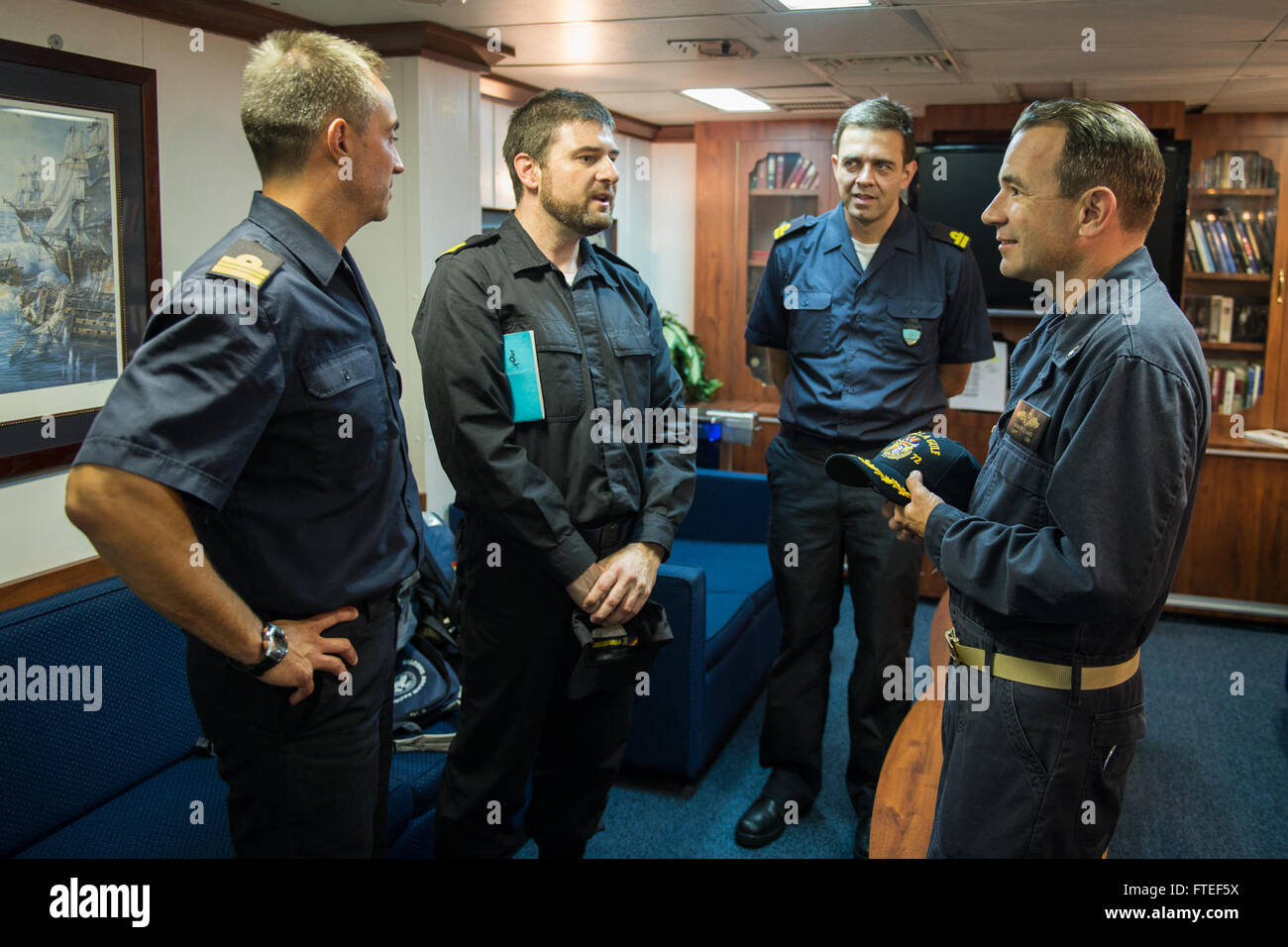 140625-N-KE519-005 MEDITERRANEAN SEA (June 25, 2014) - Capt. Robert Katz (right), commanding officer of the Ticonderoga-class guided-missile cruiser USS Vella Gulf (CG 72), speaks with sailors from the Spanish navy frigate Cristobal Colon (F 105) prior to a planning conference in the ship's wardroom. Vella Gulf, homeported in Norfolk, Va., is conducting naval operations with allies in the U.S. 6th Fleet area of operations in order to advance security and stability in Europe. (U.S. Navy photo by Mass Communication Specialist 3rd Class Edward Guttierrez III/RELEASED)  Join the conversation on <a Stock Photo