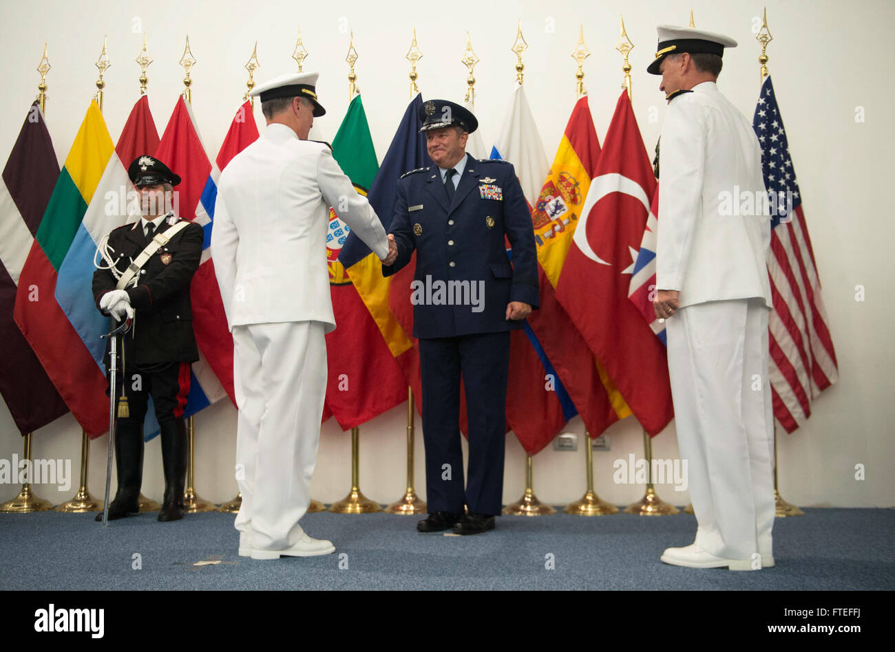 140722-N-FQ994-533 NAPLES, Italy (July 22, 2014) Gen. Philip Breedlove, Supreme Allied Commander, Europe/Commander, U.S. European Command, shakes hands with Adm. Bruce Clingan, left, after Adm. Mark Ferguson, right, relieved Clingan as Commander, Allied Joint Force Command Naples/Commander, U.S. Naval Forces Europe-Africa.  Clingan is retiring after 37 years of naval service. (U.S. Navy Photo by Mass Communication Specialist 3rd Class Weston Jones/Released) Stock Photo