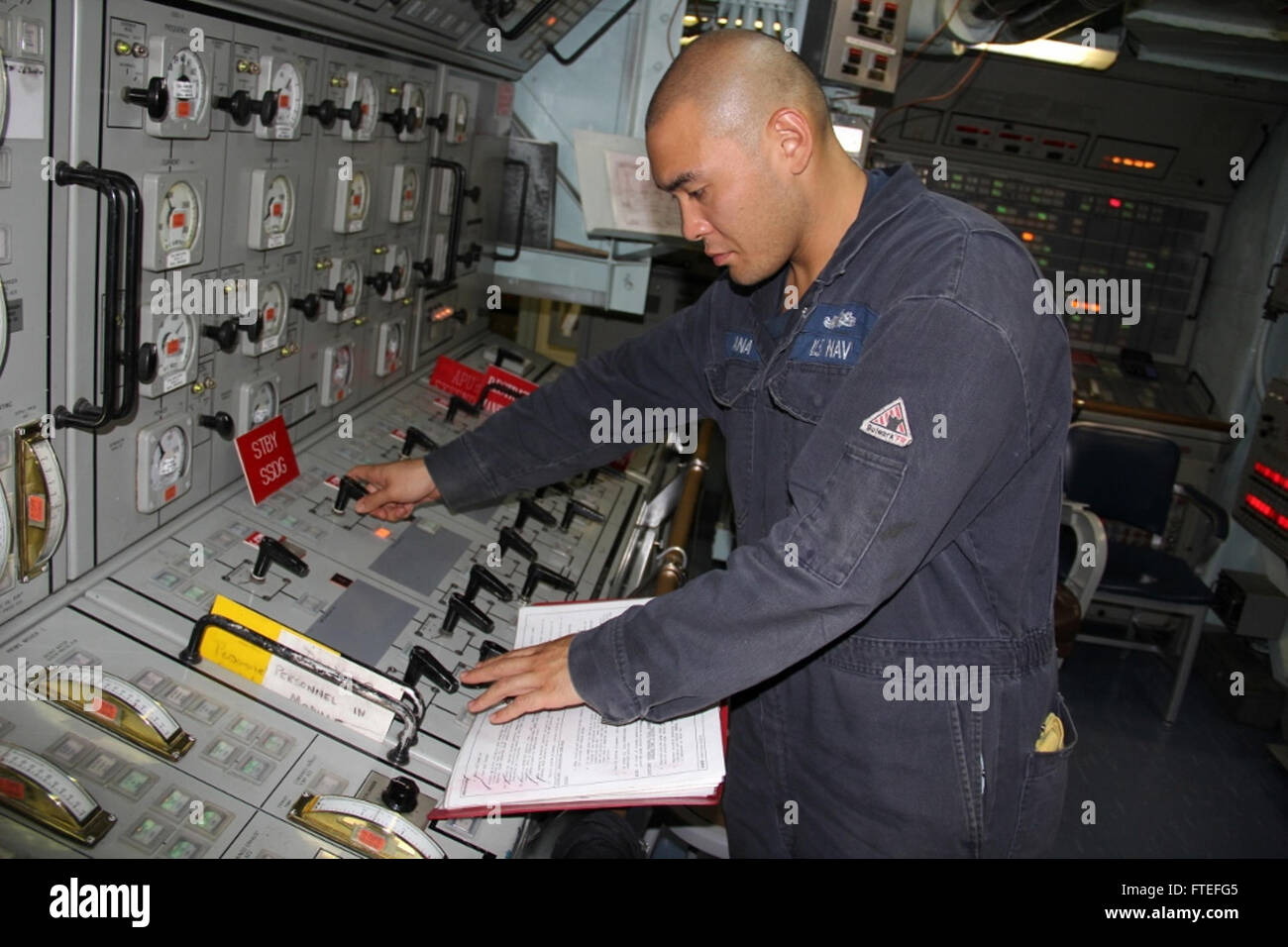 140729-N-KT328-009 MEDITERRANEAN SEA (July 29, 2014) Gas Turbine System Technician (Electrical) 2nd Class Joshua Gana goes  through the procedures to start one of the ship’s diesel generators aboard the guided-missile frigate USS Samuel B. Roberts (FFG-58). Samuel B. Roberts, homeported in Mayport, Fla., is conducting naval operations in the U.S. 6th Fleet area of operations in support of U.S. national security interests in Europe and Africa. (U.S. Navy photo by Ensign Evan Albright) Stock Photo