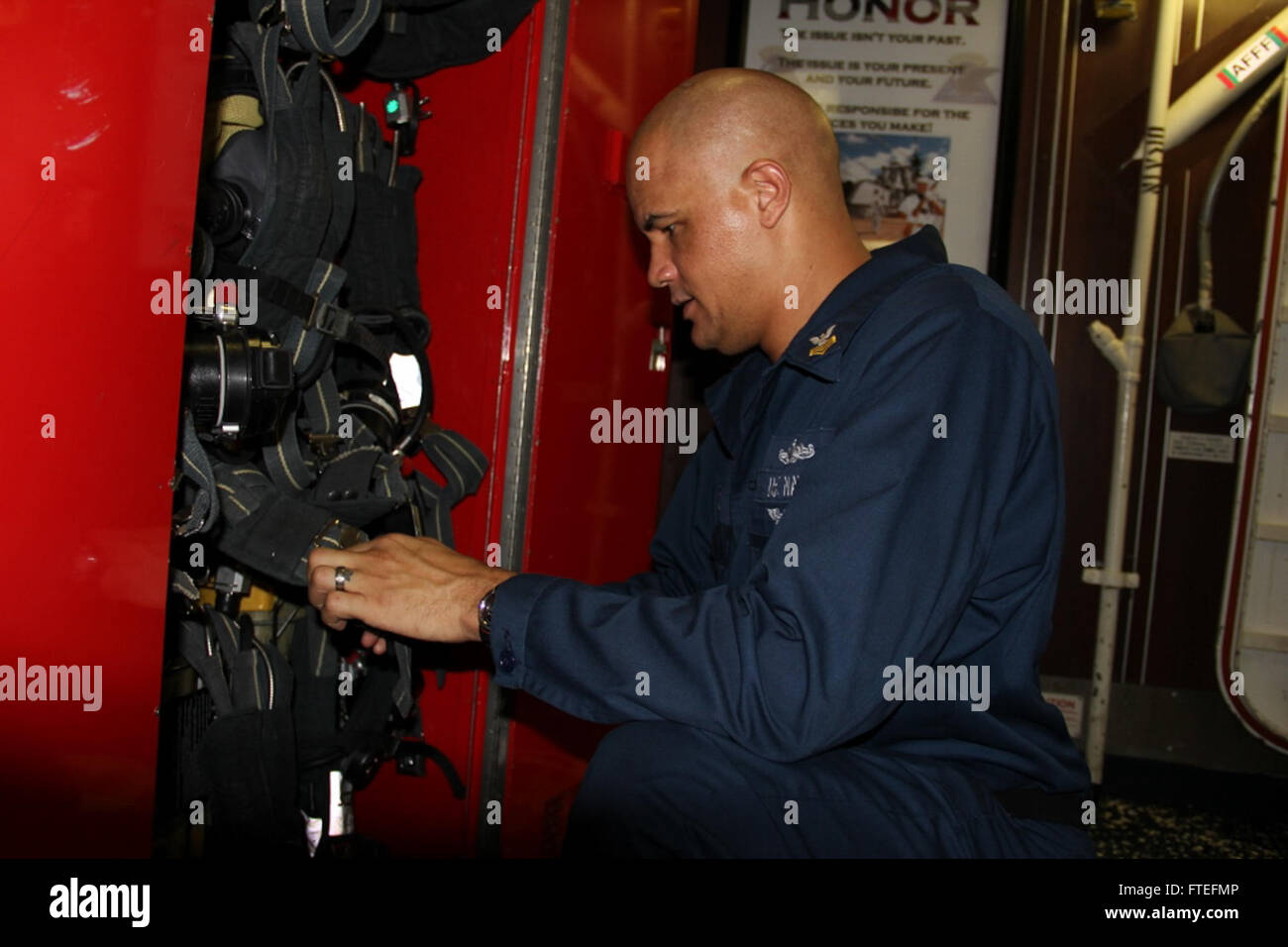 This image captures Damage Controlman 1st Class Jeremy Ruud inspecting a self-contained breathing apparatus aboard the USS Samuel B. Roberts (FFG 58), an Oliver Hazard Perry-class guided-missile frigate, while conducting naval operations in the Mediterranean Sea. Stock Photo