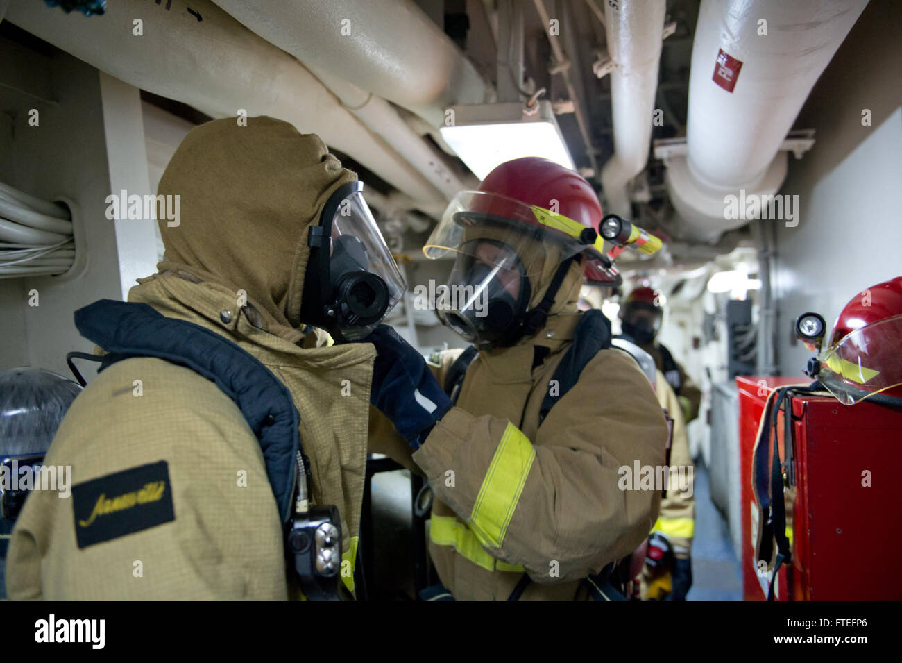 140809-N-ZE250-085  BLACK SEA (Aug. 9, 2014) Sailors check each other’s firefighting equipment during a damage control exercise aboard the Ticonderoga-class guided-missile cruiser USS Vella Gulf (CG 72). Vella Gulf, homeported in Norfolk, Va., is conducting naval operations with allies in the U.S. 6th Fleet area of operations in order to advance security and stability in Europe. (U.S. Navy photo by Mass Communication Specialist 3rd Class Weston Jones/Released) Stock Photo