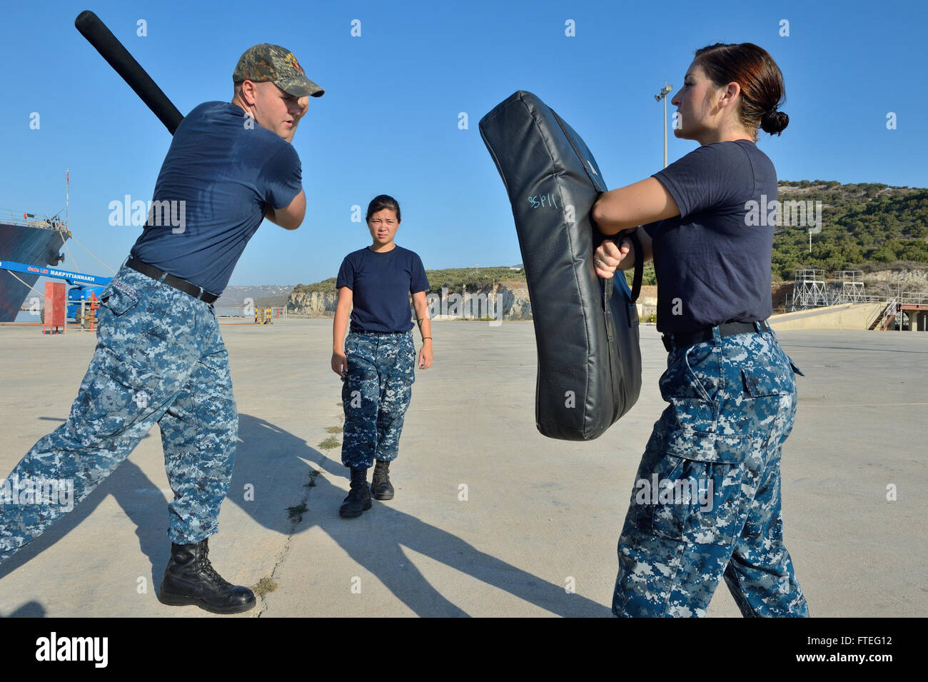 140828-N-IY142-145 SOUDA BAY, Greece (Aug. 28, 2014) Fire Controlman 2nd Class Brian Beddoes demonstrates baton techniques during force protection training with Sailors from the Arleigh Burke-class guided-missile destroyer USS Ross (DDG 71). Ross, forward deployed to Rota, Spain, is conducting naval operations in the U.S. 6th Fleet area of operations in support of U.S. national security interests in Europe. (U.S. Navy photo by Mass Communication Specialist 2nd Class John Herman/Released) Stock Photo