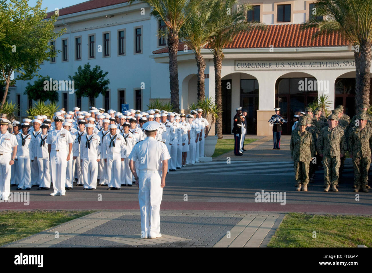 NAVAL STATION ROTA, Spain (July 2, 2015) – Cmdr. Neil Hoffman, Rota’s executive officer, awaits the arrival of the official party during the annual flag-raising ceremony aboard Naval Station Rota, Spain, July 2. While raising the flag is a daily occurrence on most U.S. military installations around the world, Naval Station Rota is only permitted to fly the American flag with special permission from the base’s Spanish admiral in chief in accordance with the Agreement on Defense Cooperation. (U.S. Navy photo by Mass Communication Specialist 2nd Class Grant Wamack/Released) Stock Photo