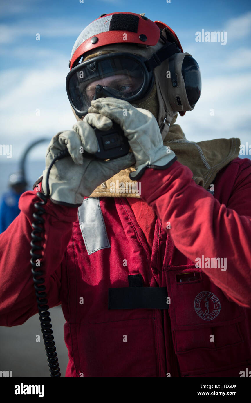 140927-N-RB546-324 ATLANTIC OCEAN (Sep. 27, 2014) Machinery Repairman 2nd Class Chase Fleck reports the status of a mock fire during a damage control training drill aboard the Arleigh Burke-class guided-missile destroyer USS Mitscher (DDG 57). Mitscher, homported in Norfolk, Va., is conducting naval operations in the U.S. 6th Fleet area of responsibility in support of U.S. national security interests in Europe.  (U.S. Navy photo by Mass Communication Specialist 2nd Class Anthony R. Martinez/Released) Stock Photo