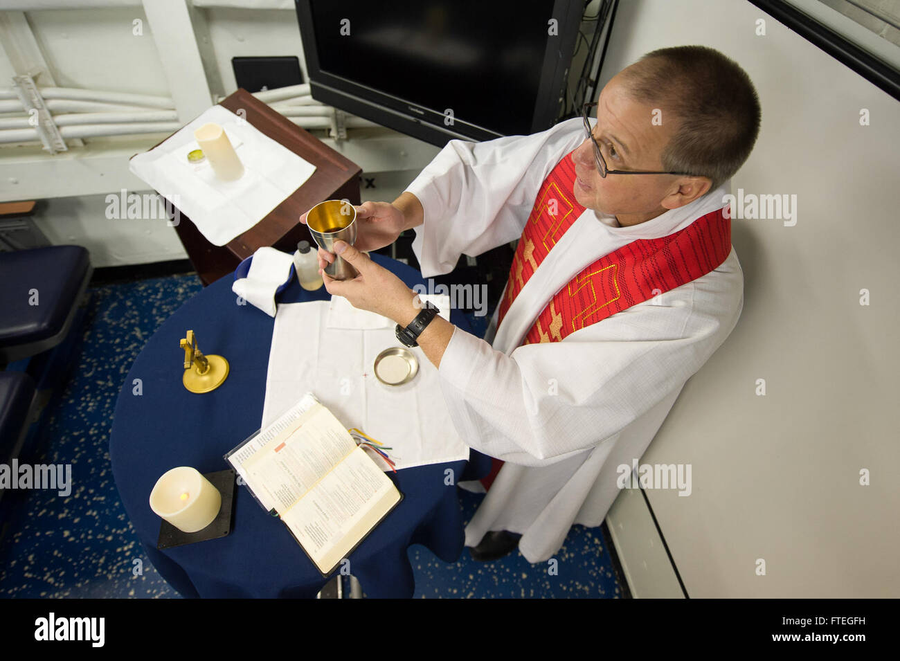 140929-N-WD757-324 CIVITAVECCHIA, Italy (Sept. 29, 2014) Canadian Forces army Chaplain Major Bastien Leclerc leads a Roman Catholic confirmation service aboard the guided-missile destroyer USS Arleigh Burke (DDG 51). Arleigh Burke, homeported in Norfolk, Va., is conducting naval operations in the U.S. 6th Fleet area of operations in support of U.S. national security interests in Europe. (U.S. Navy photo by Mass Communication Specialist 2nd Class Carlos M. Vazquez II/Released) Stock Photo