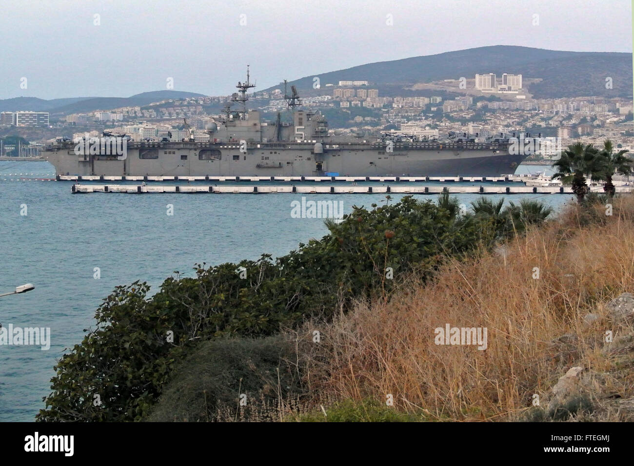 KUSADASI, Turkey (Oct. 4, 2014) The amphibious assault ship USS Bataan (LHD 5) sits pier side for a port call in Kusadasi, Turkey. The Bataan Amphibious Ready Group is on a scheduled deployment supporting maritime security operations, providing crisis response capability and theater security cooperation efforts in the U.S. 6th Fleet area of operations. Stock Photo