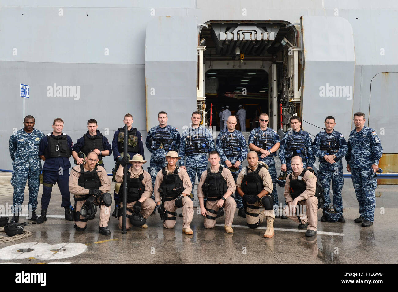 SPLIT, Croatia (Oct. 7, 2014) Sailors and members of the Croatian and Slovenian navies pose for a group photo in front of the amphibious transport dock ship USS Mesa Verde (LPD 19) while participating in a joint visit, board, search and seizure (VBSS) training during a scheduled port visit. Mesa Verde, part of the Bataan Amphibious Ready Group with the embarked 22nd Marine Expeditionary Unit, is conducting naval operations in the U.S. 6th Fleet area of operations in support of U.S. national security interests in Europe. Stock Photo