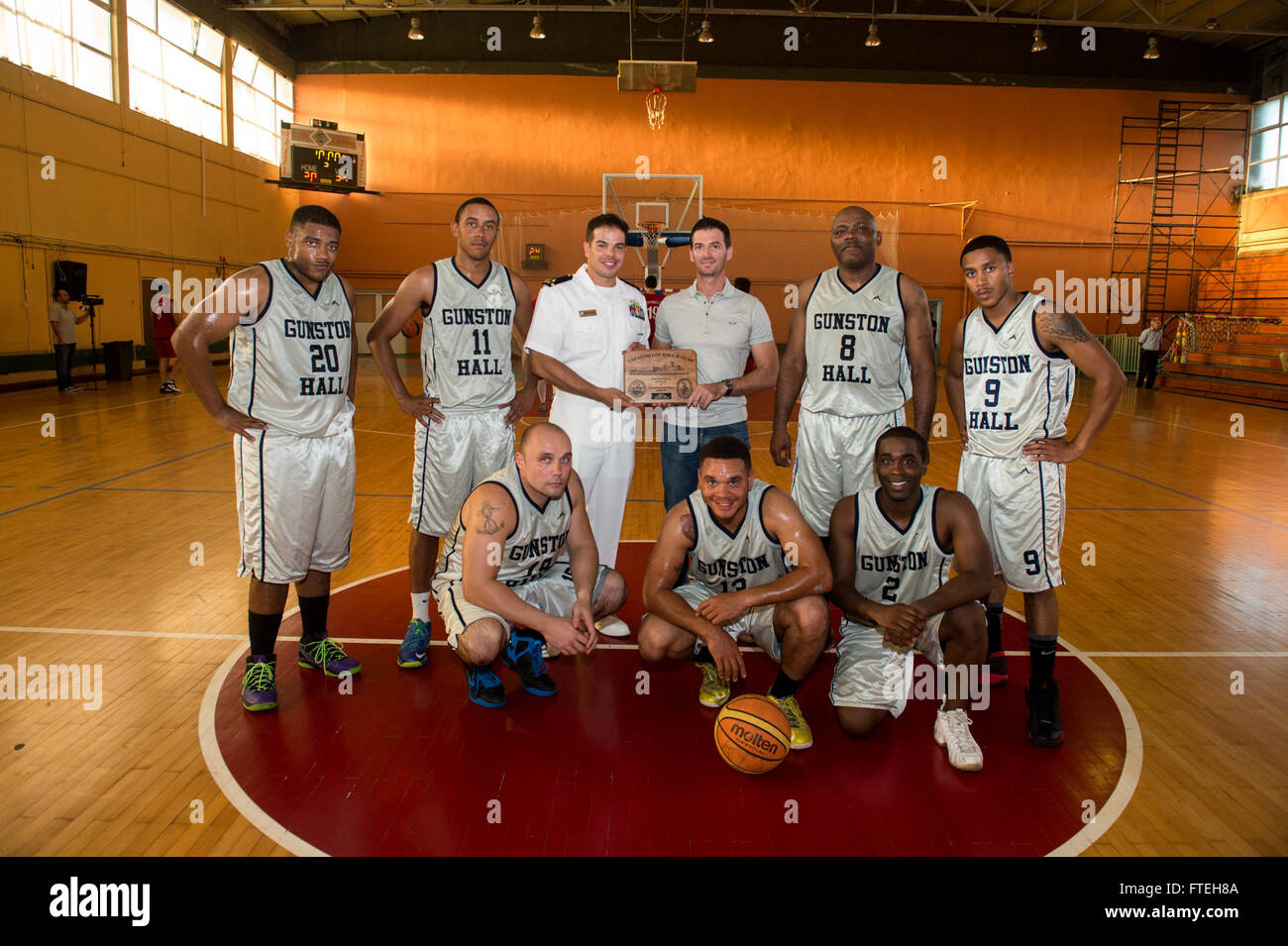 CORFU, Greece (Oct. 11, 2014) –  Sailors from the amphibious dock landing ship USS Gunston Hall (LSD 44) exchange gifts during a friendly basketball game with a local team while in port. This port visit serves to continue efforts to strengthen maritime partnerships in order to enhance regional stability. Gunston Hall is part of the Bataan Amphibious Ready Group, and with the embarked 22nd Marine Expeditionary Unit, is deployed in support of maritime security operations and theater security cooperation efforts in the U.S. 6th Fleet area of responsibility. Stock Photo