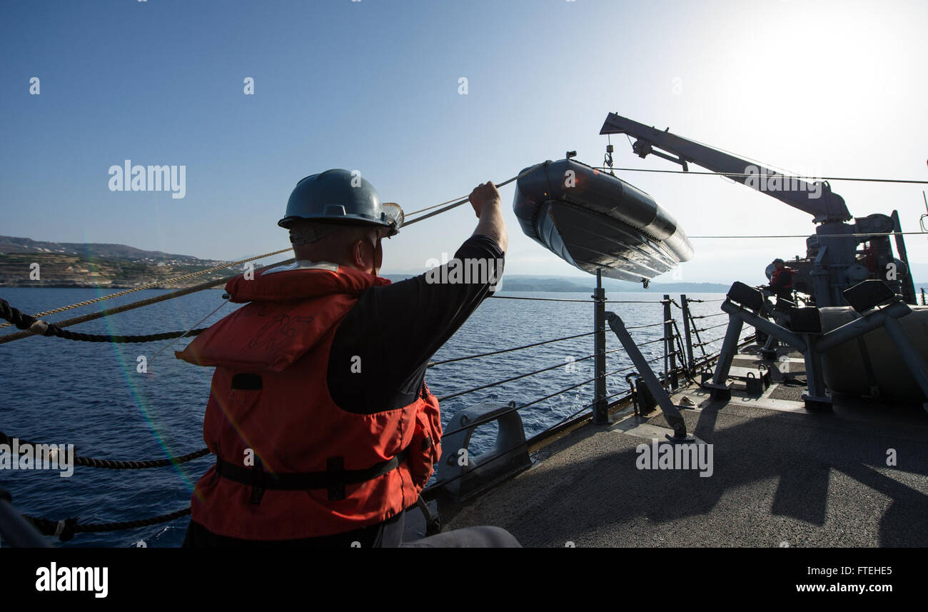 MEDITERRANEAN SEA (Oct. 15, 2014) Boatswain’s Mate 1st Class Jason Harrison signals to Boatswain