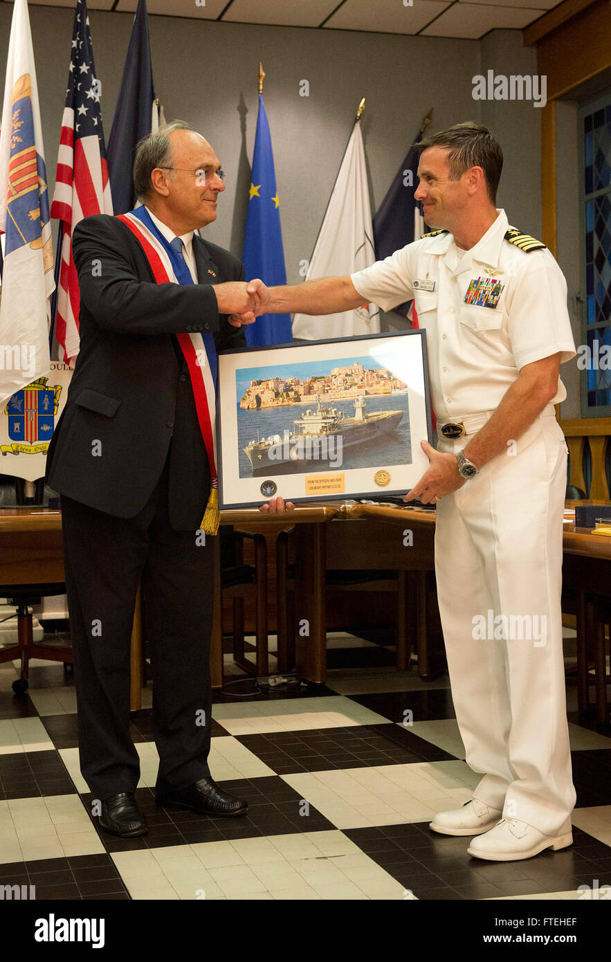 THEOULE-SUR-MER, France (August 14, 2013) –Daniel Mansanti, left, mayor of Theoule-sur-Mer, receives a photo from Capt. Craig Clapperton, commanding officer of the amphibious command ship USS Mount Whitney (LCC 20) during a gift exchange in recognition of the 69th anniversary celebration of allied troops landing in Provence during World War II. This visit serves to continue U.S. 6th Fleet efforts to build global maritime partnerships with European nations and improve maritime safety and security. Stock Photo