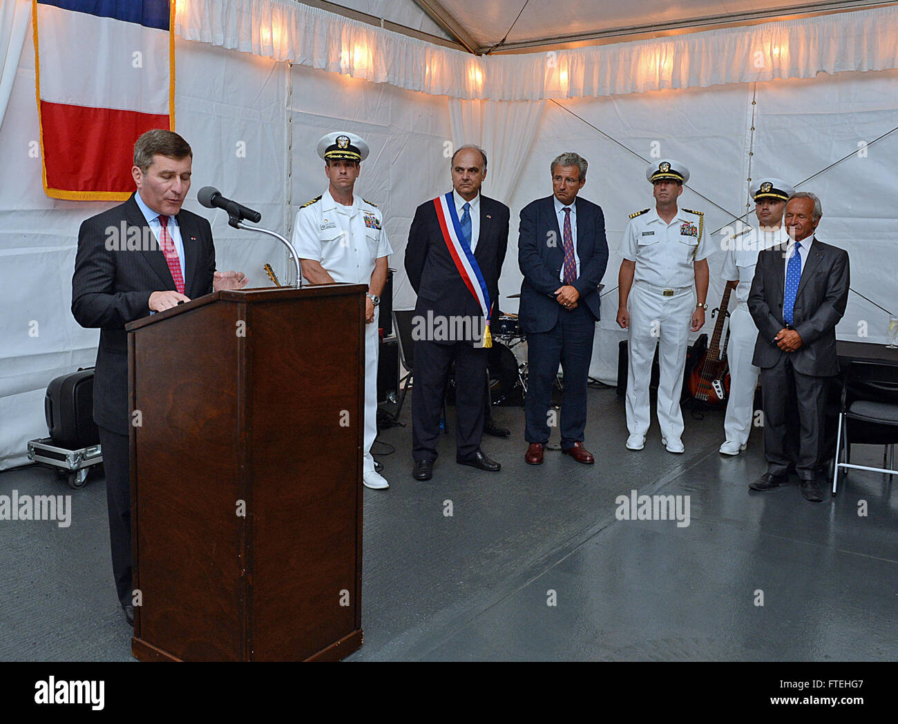 THEOULE-SUR-MER, France (August 14, 2013) – Charles Rivkin, left, United States Ambassador to France and Monaco addresses local residents and dignitaries on board the amphibious command ship USS Mount Whitney (LCC 20), during a reception in recognition of the 69th anniversary celebration of allied troops landing in Provence during World War II. This visit serves to continue U.S. 6th Fleet efforts to build global maritime partnerships with European nations and improve maritime safety and security. Stock Photo