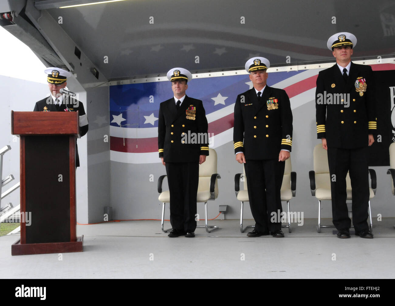 NAVAL STATION ROTA, Spain (October 17, 2014) – Cmdr. Scott Jones, left, reads his orders during USS Donald Cook (DDG 75) change of command ceremony, Oct. 17. Donald Cook is the first of four Arleigh Burke-class destroyers to be forward-deployed to Rota, Spain, as part of the President's European Phased Adaptive Approach (EPAA) to ballistic missile defense in Europe. Stock Photo